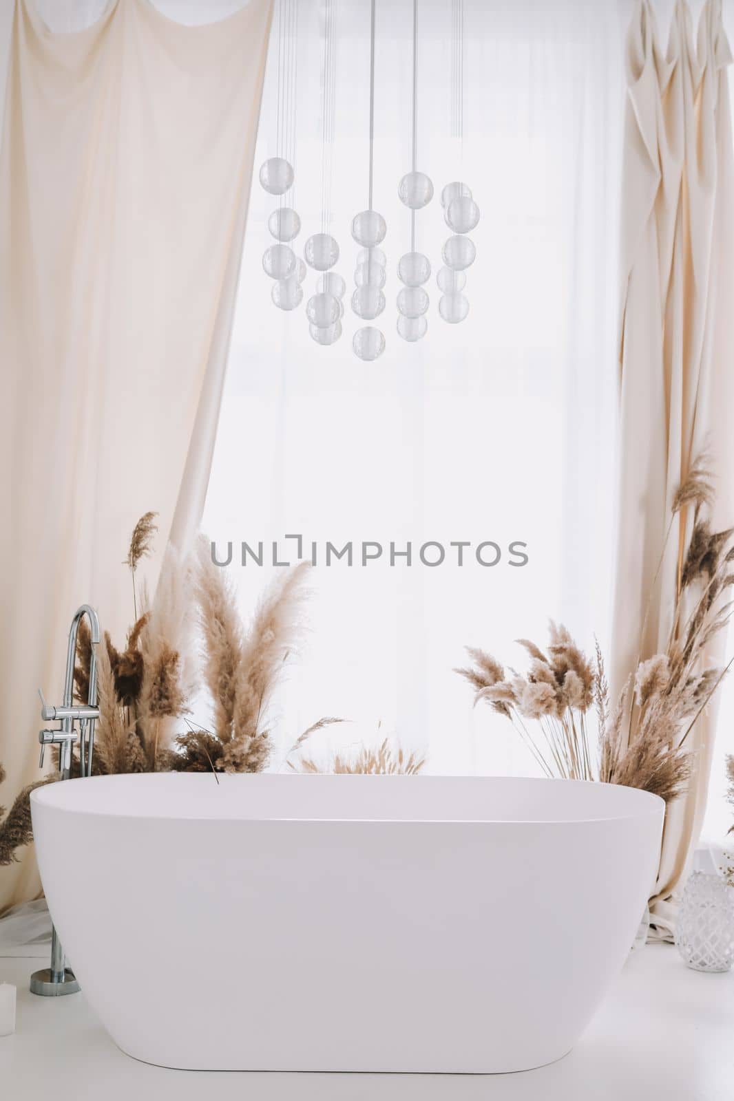 Modern white bathroom. White bath in a room with white walls. Interior design by paralisart