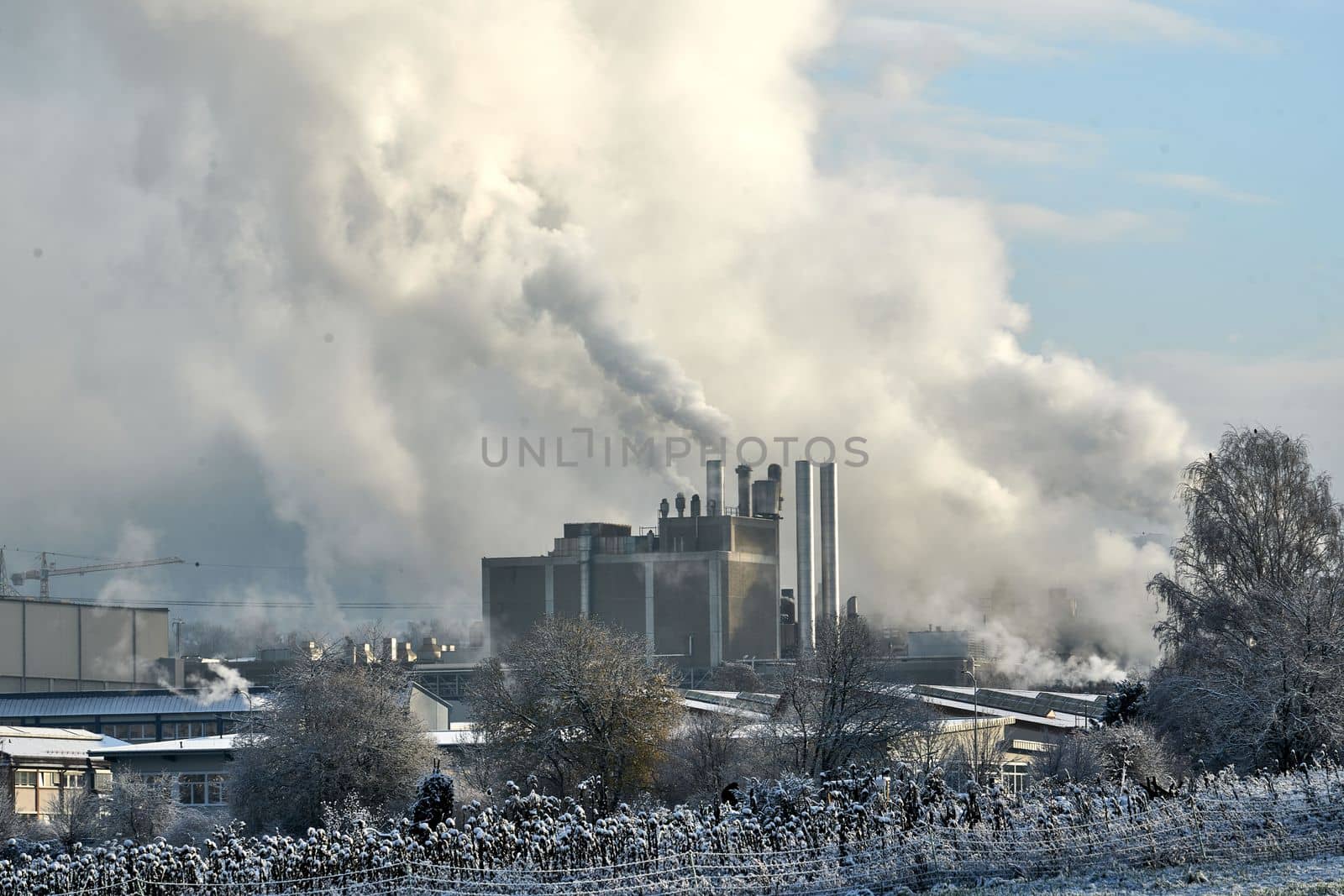 Environmental problem of pollution of environment and air in cities. Smoking industrial zone factory chimneys. View of large plant with Smoking pipes Smoke from the paper industry, which is running every day of the year. Photo taken December 2022 Air pollution in the city. Smoke from the chimney on blue sky background. High quality photo