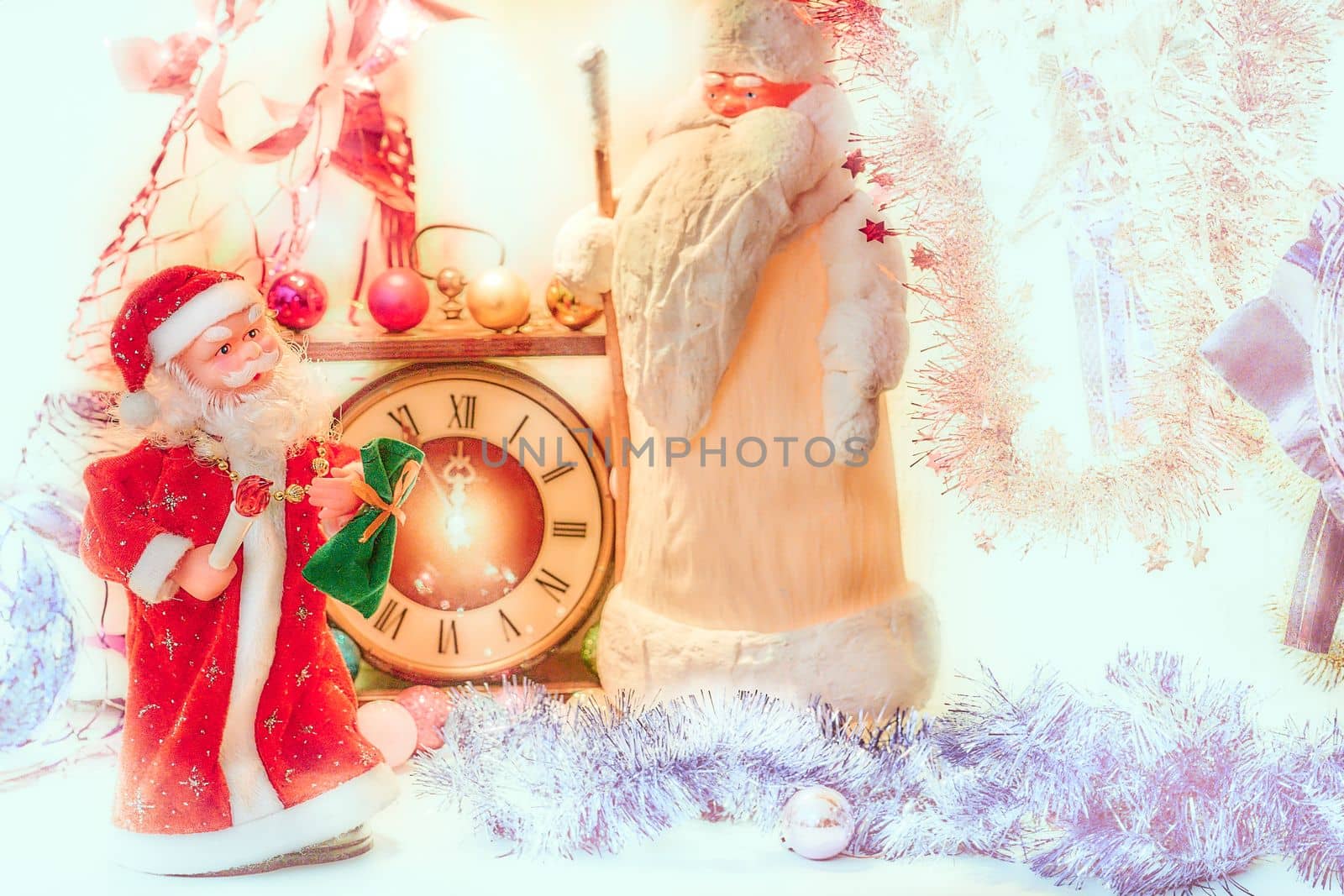 the annual Christian festival celebrating Christ's birth, held on December 25 in the Western Church. Two Santa Claus and vintage clock in bright golden silver Christmas New Year lights