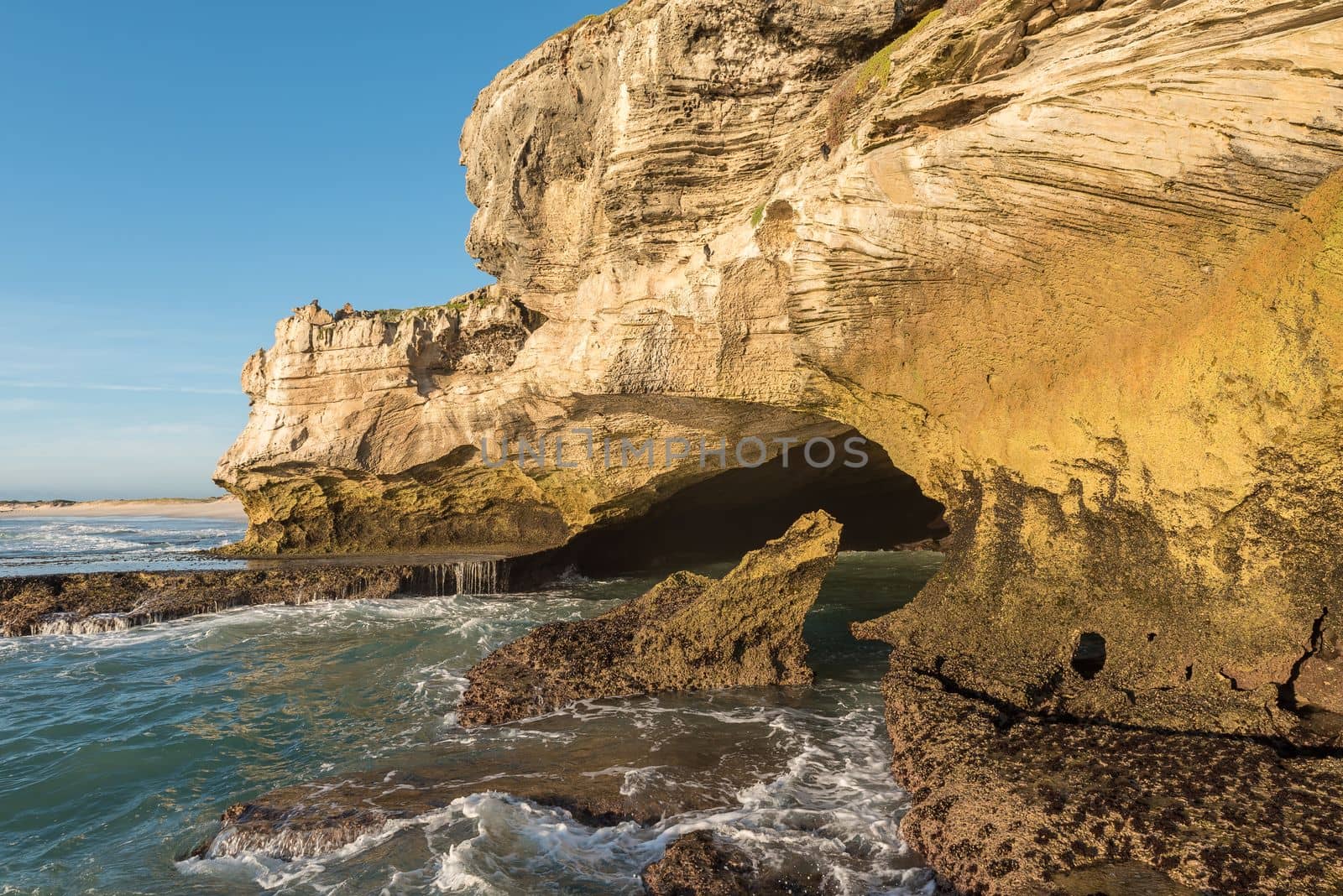 Ocean-side mouth of the Waenhuiskrans Cave near Arniston by dpreezg