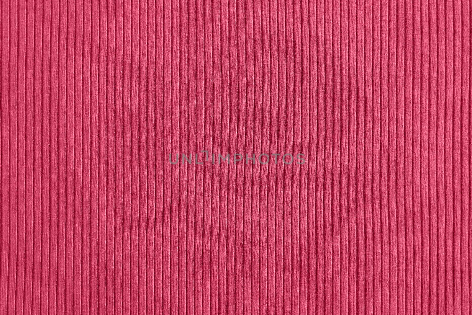 Viva magenta color of the year 2023, ribbed texture of cloth. Fabric pattern