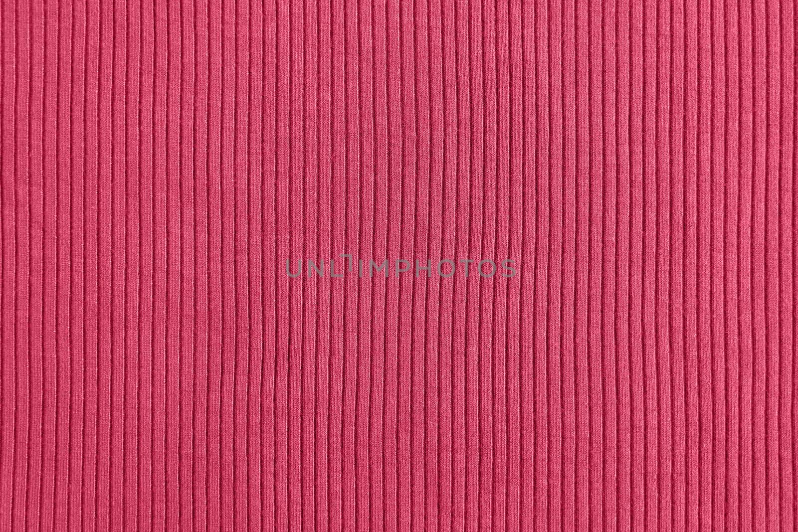 Viva magenta color of the year 2023, ribbed texture of cloth. Fabric pattern