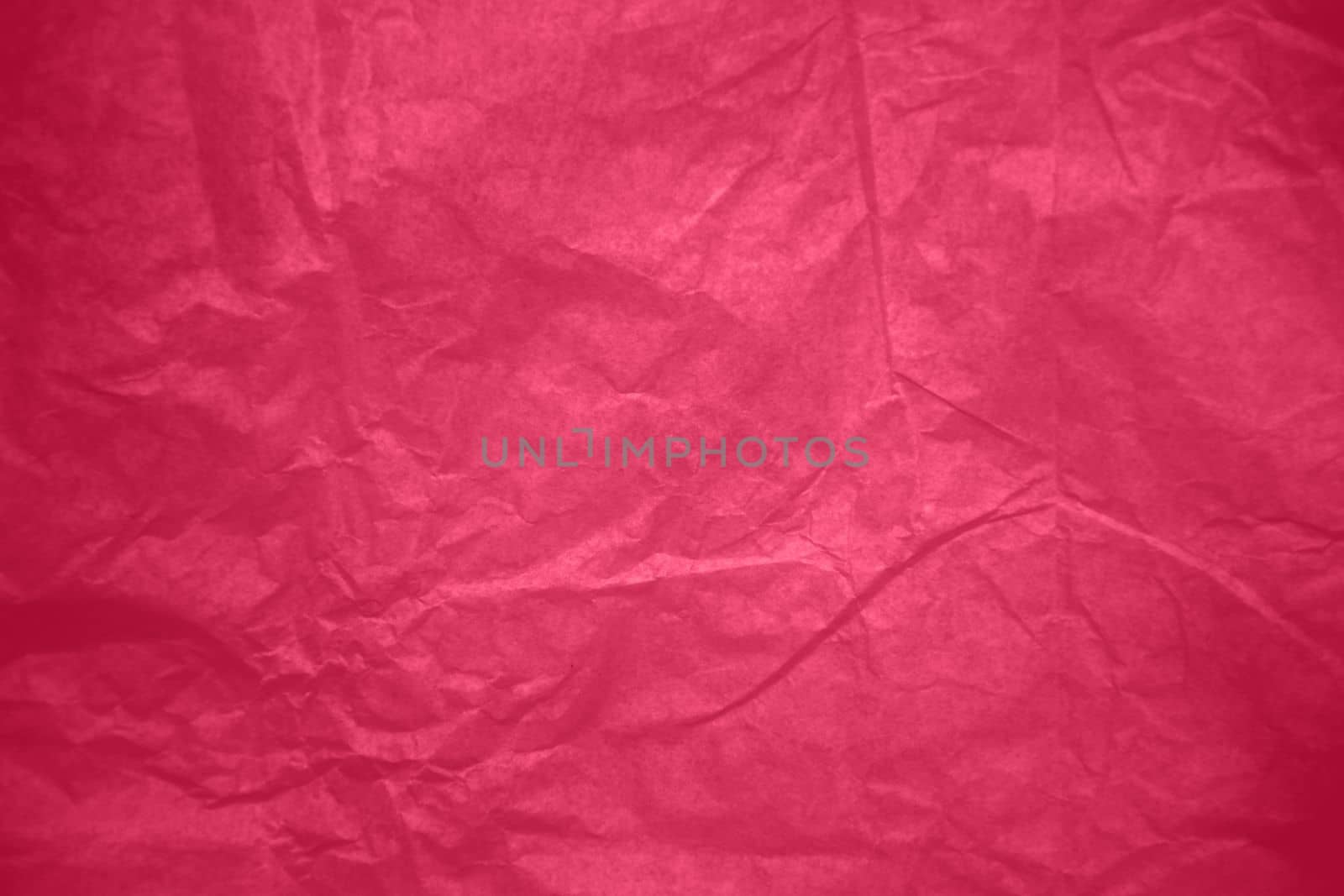 Crumpled paper Viva Magenta color of the year 2023. Texture crumpled paper for your design. Copy space. Viva Magenta color paper. High quality photo