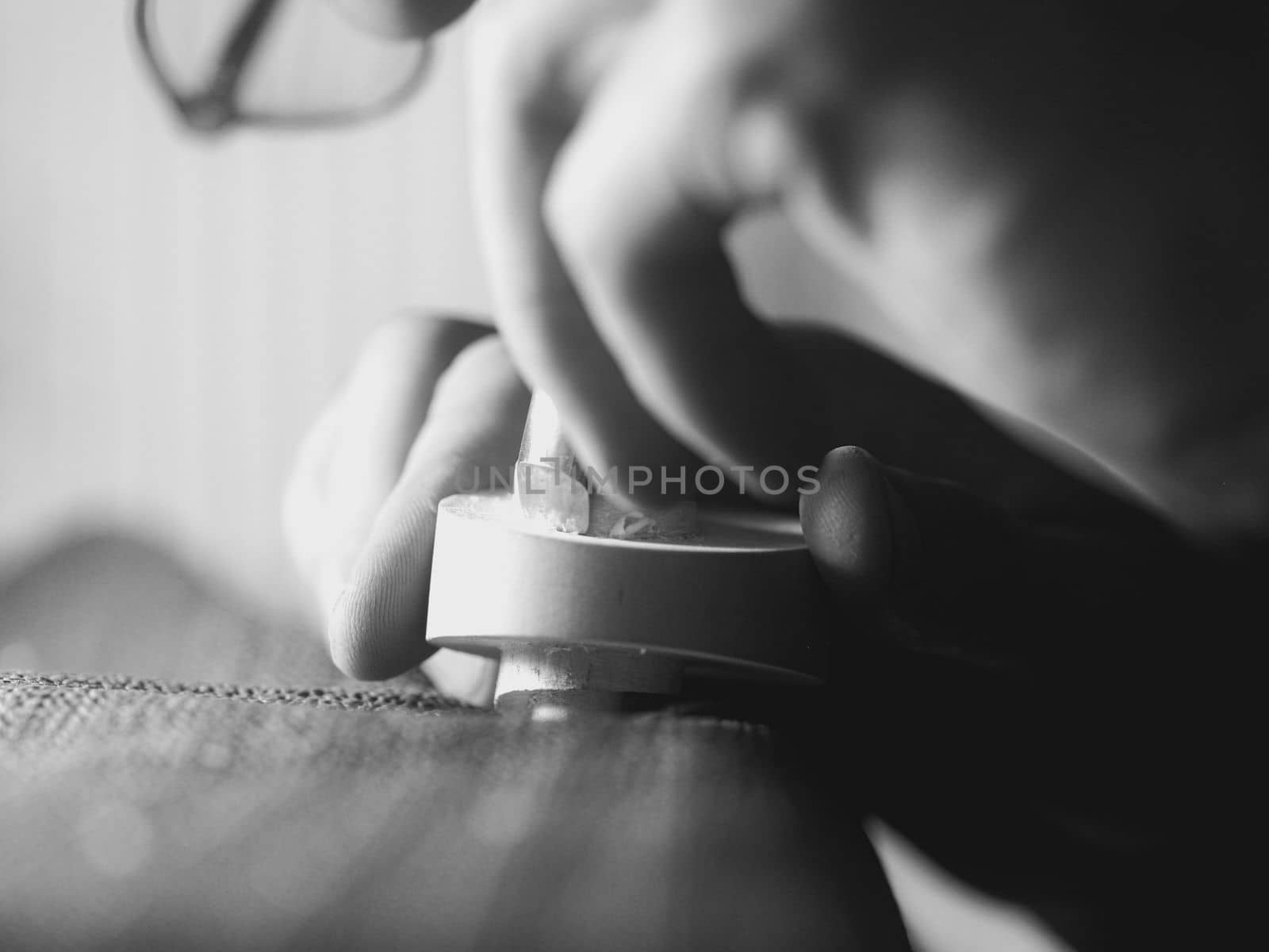violinmaker working on a handmade contemporary stringed instrument scroll