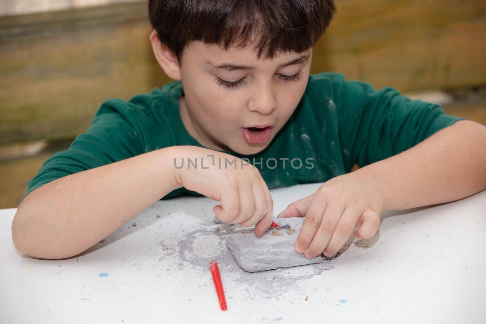 children's entertainment, a child plays in an archaeologist, children's hands dig dinosaur bones