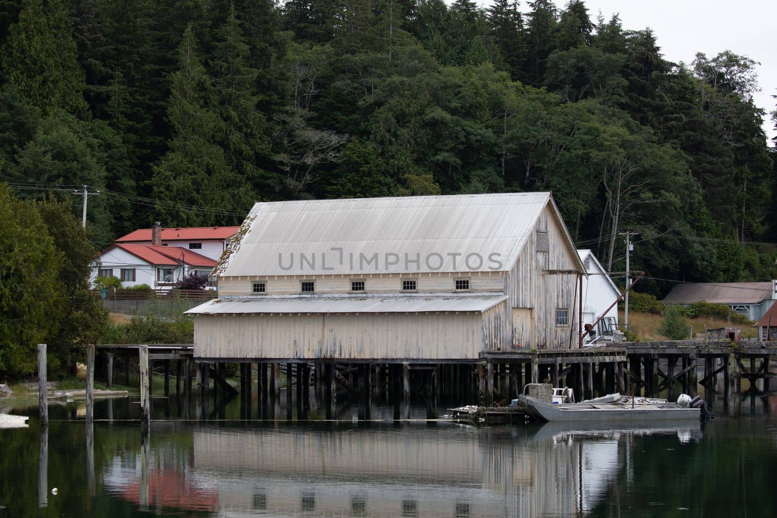 Fishboat wharf and shed with reflection in water at Sointula, Malcolm Island, British Columbia, Canada