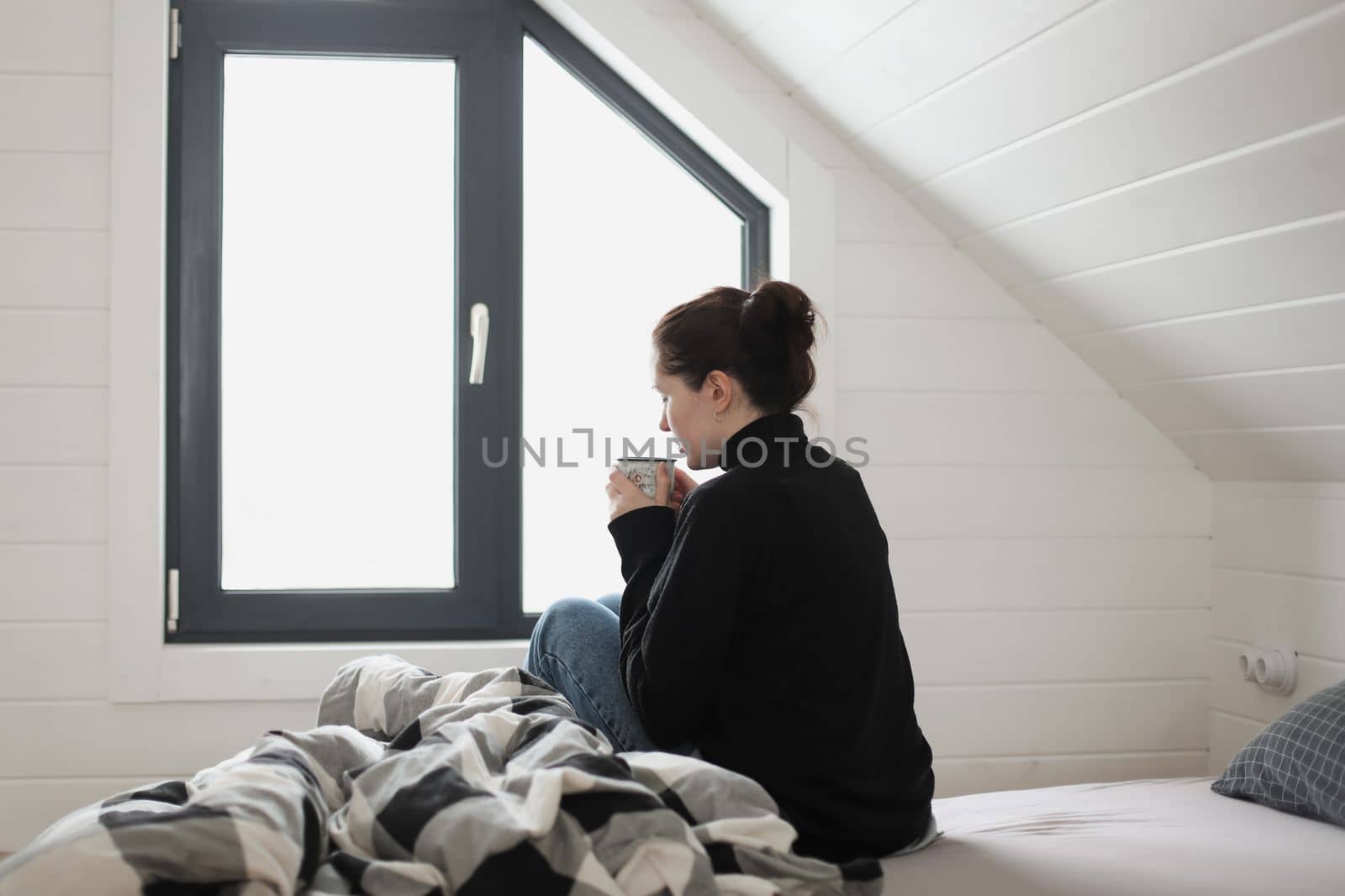 young woman drink coffee and enjoy a wonderful morning in the light room at home.