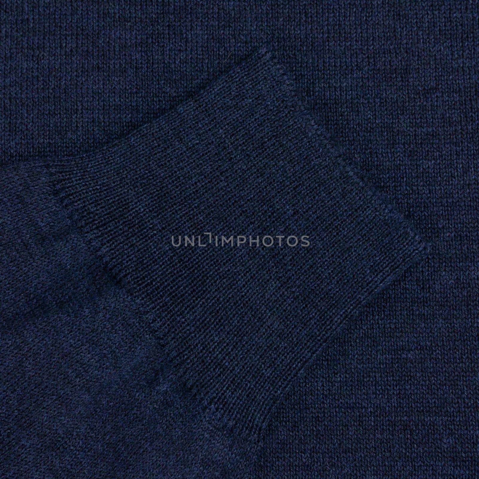 Blue wool sweater sleeve close up background