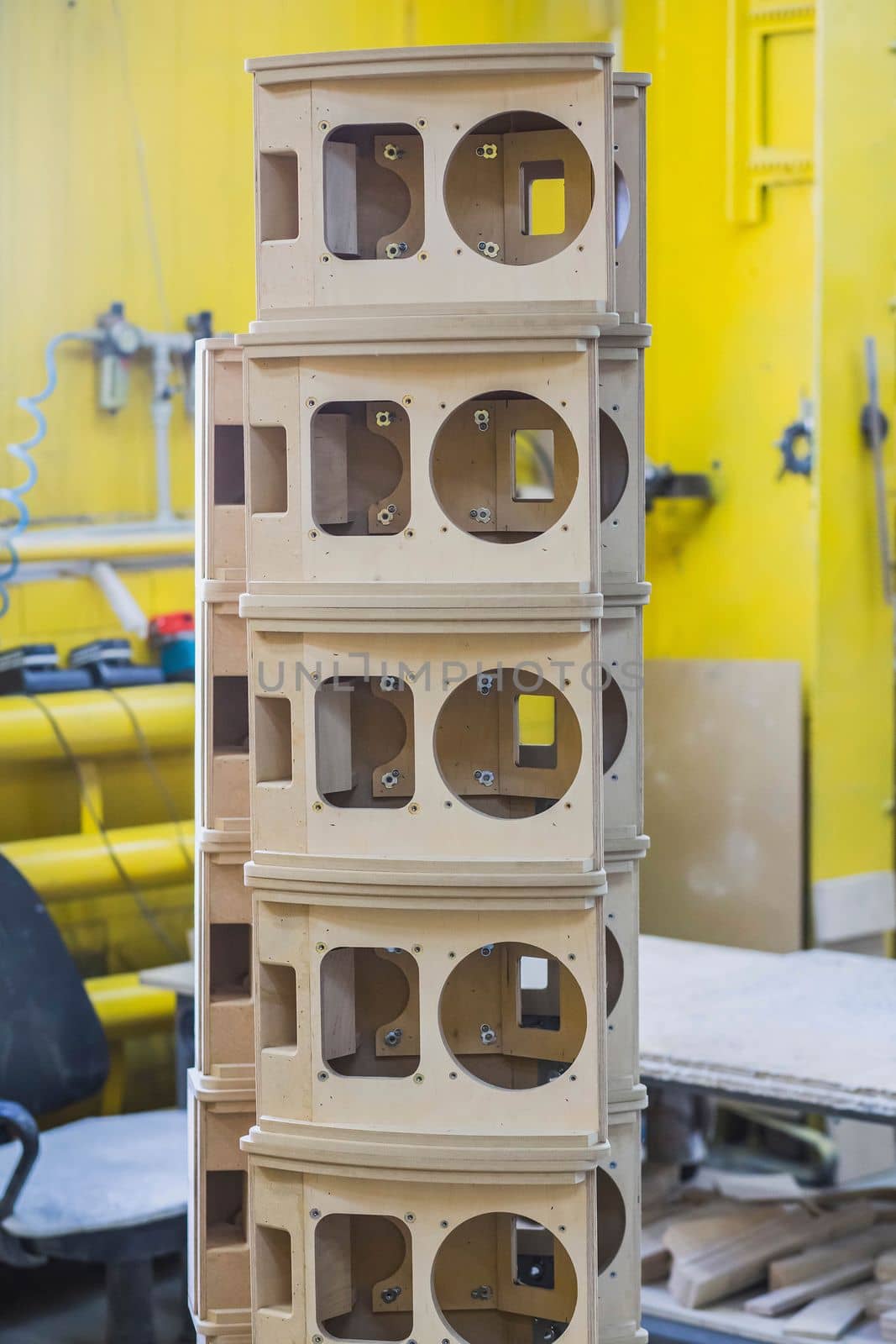 wooden bases Audio Speakers stacked like a tower at the factory.