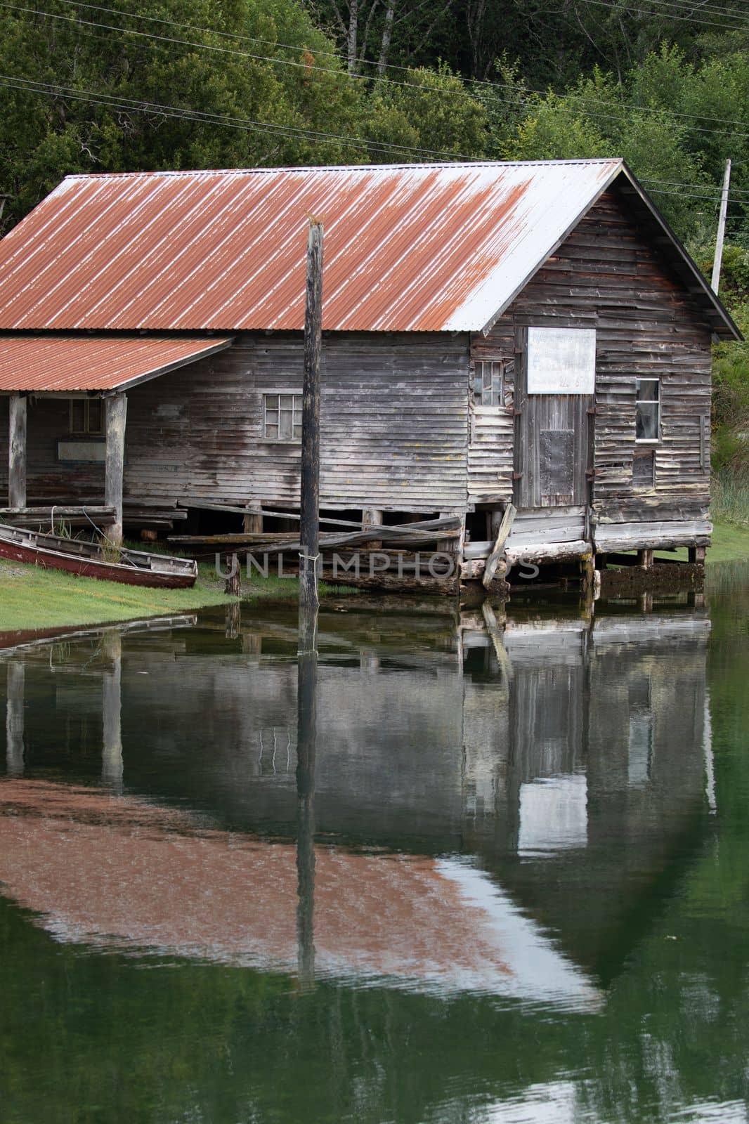 Fisheries shed with reflection in water at Sointula, Malcolm Island, British Columbia, Canada