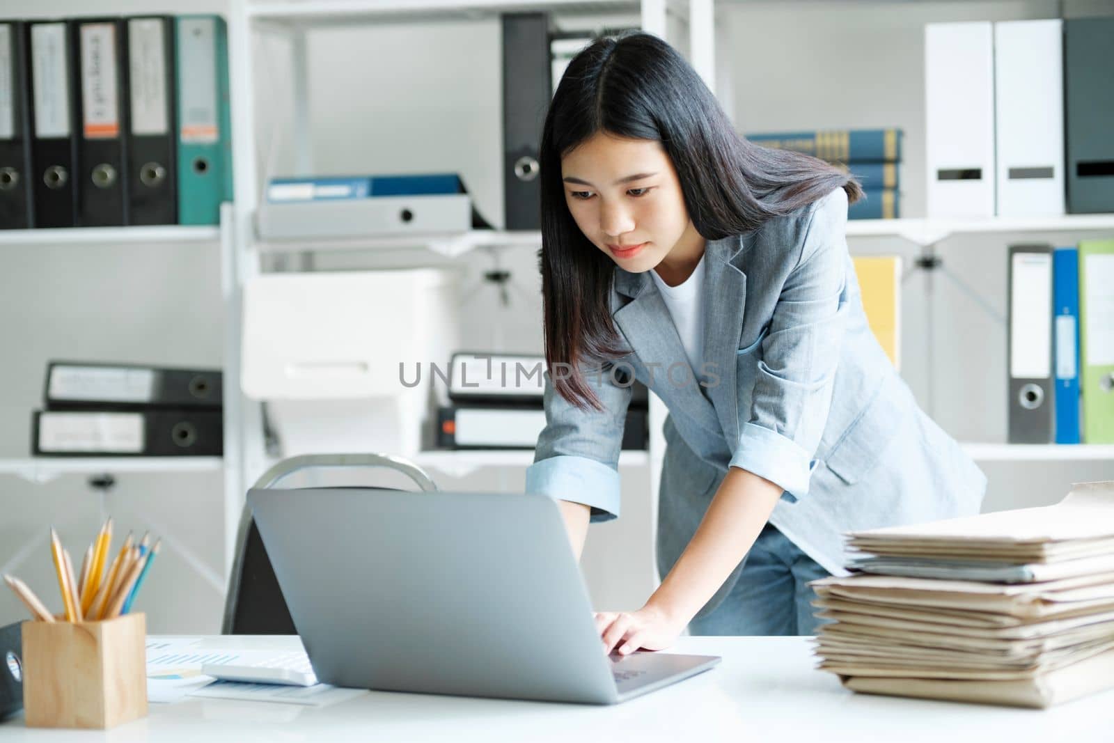 Young asian businesswoman working at office using laptop. by ijeab