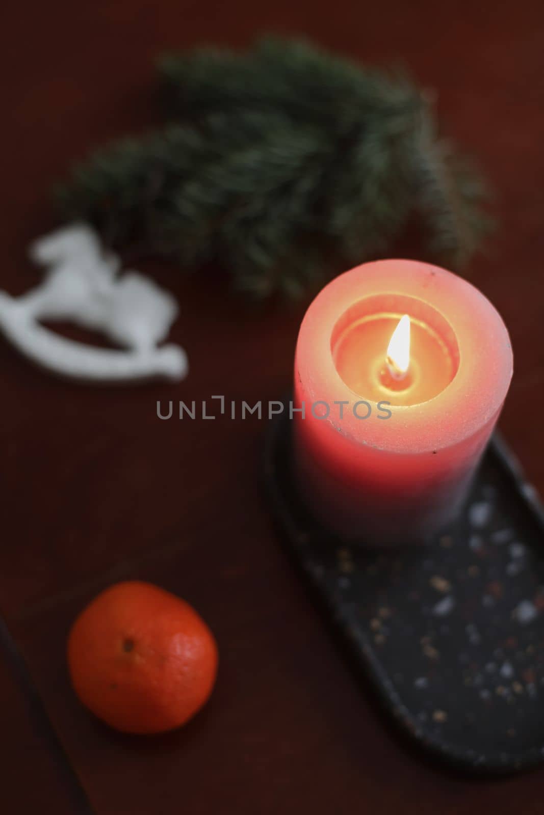 Christmas Toy horse, candle, tangerines and pine cone. Winter holiday items for home decor. Flat lay stock photography.
