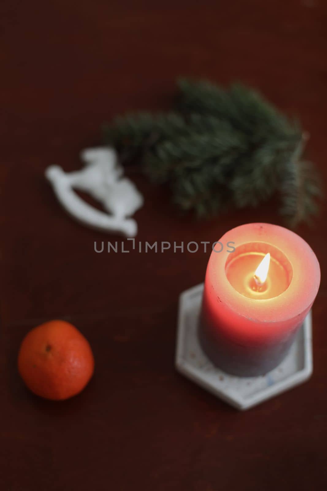 Christmas Toy horse, candle, tangerines and pine cone. Winter holiday items for home decor. Flat lay stock photography.