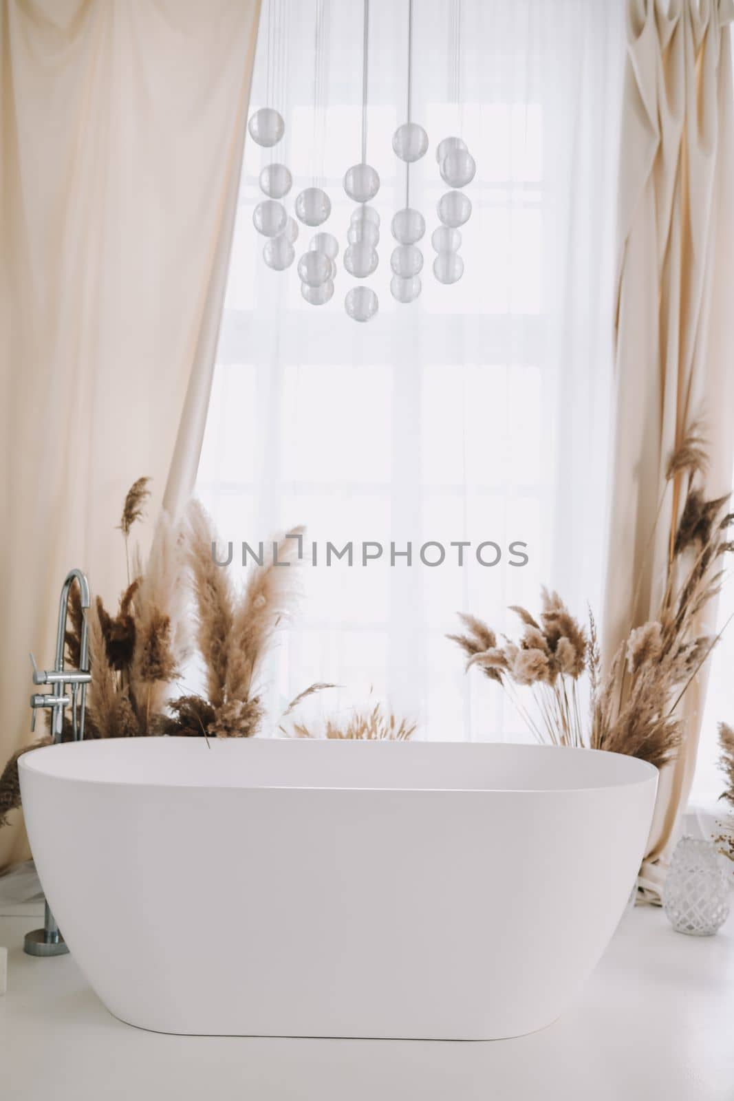 Modern white bathroom. White bath in a room with white walls. Interior design by paralisart