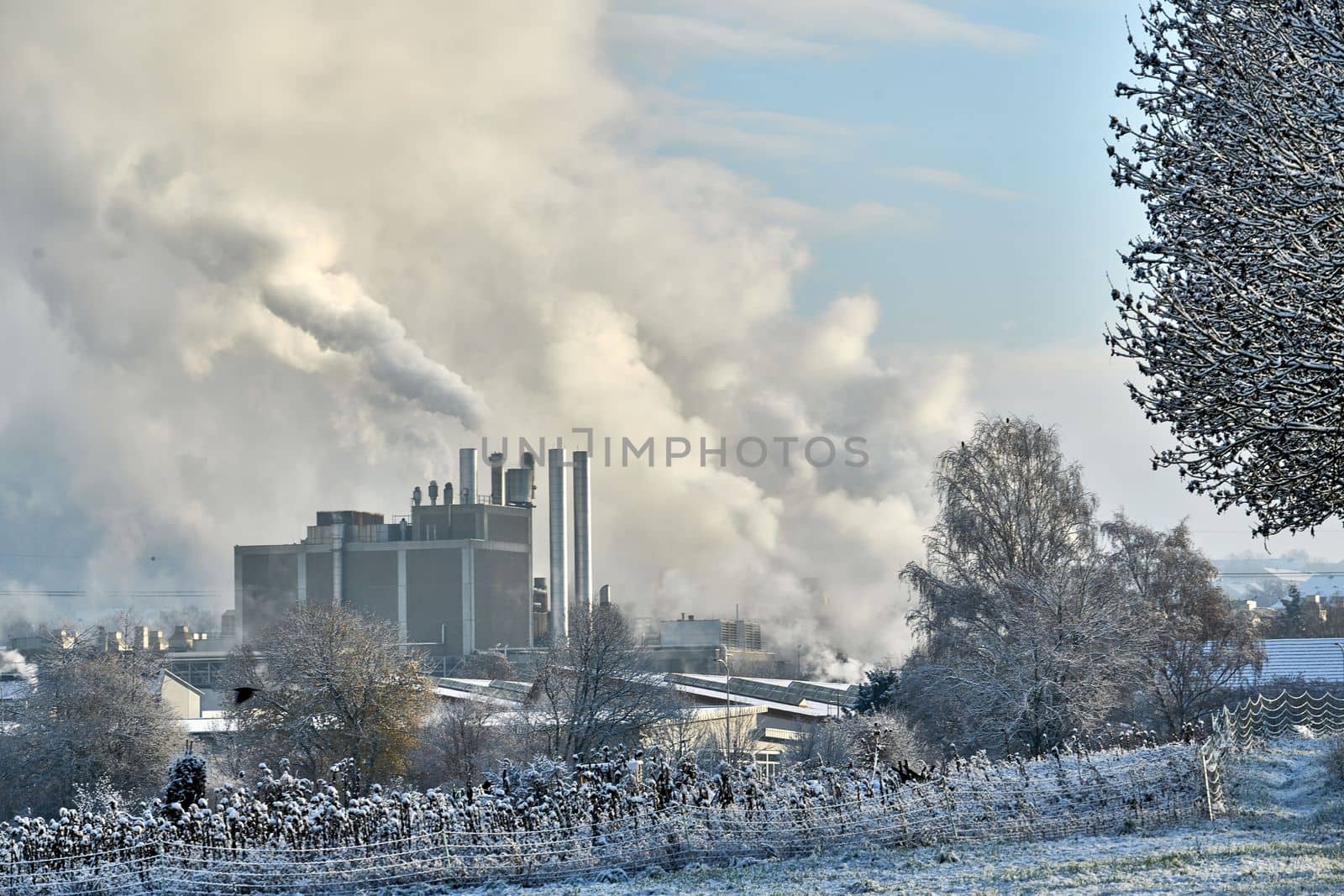 Environmental problem of pollution of environment and air in cities. Smoking industrial zone factory chimneys. View of large plant with Smoking pipes Smoke from the paper industry, which is running every day of the year. Photo taken December 2022 Air pollution in the city. Smoke from the chimney on blue sky background. High quality photo