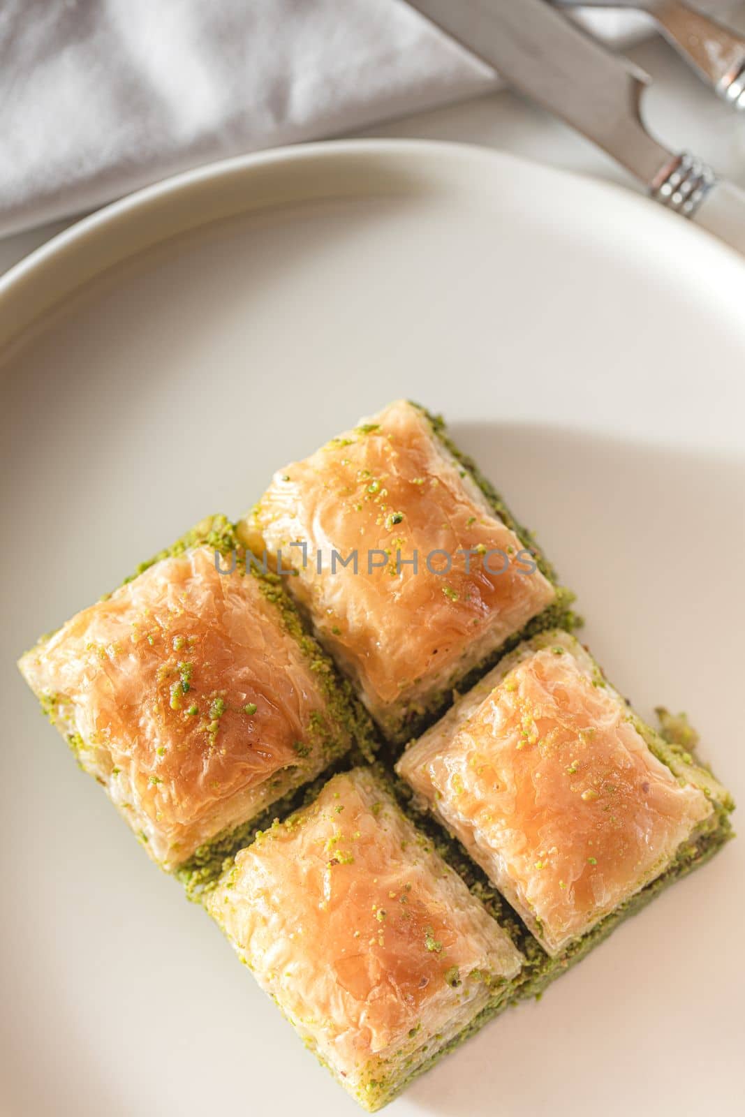 Traditional, delicious Turkish baklava on white plate by senkaya