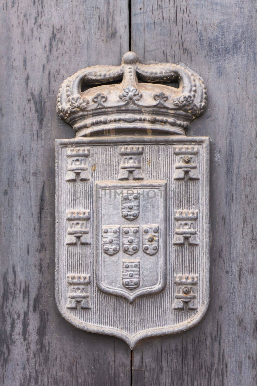 Ancient Portuguese coat of arms with crown, towers and shields close up
