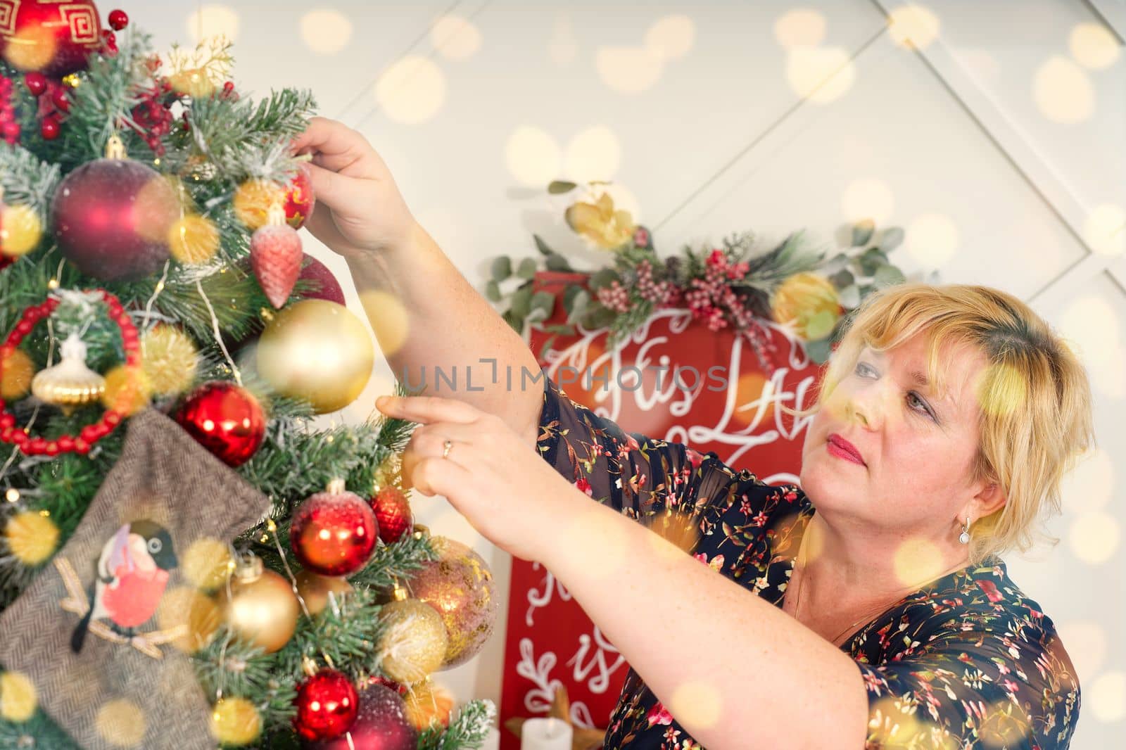 Woman decorating beautiful Christmas tree at home, closeup. christmas holidays and people concept. by PhotoTime