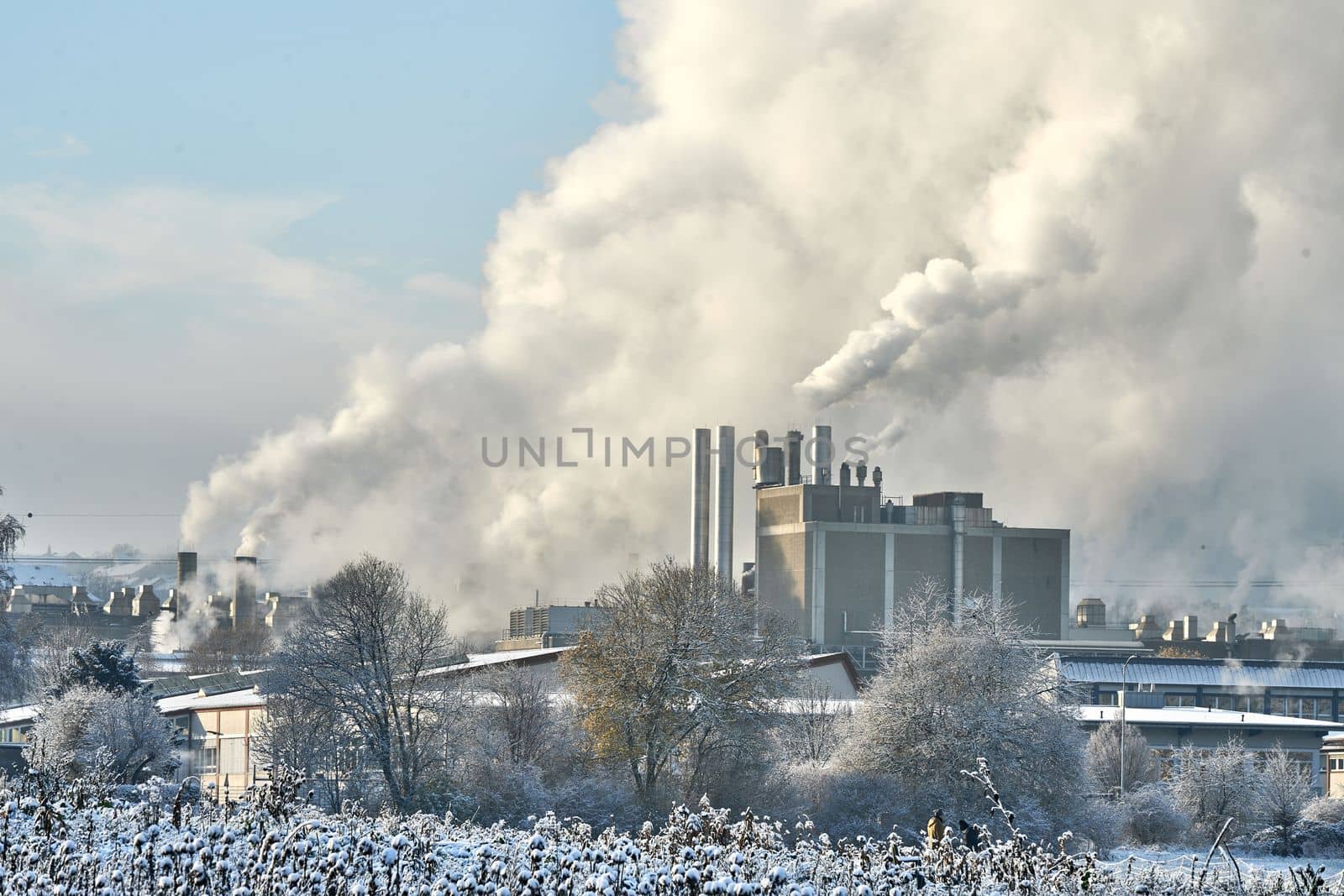 Environmental problem of pollution of environment and air in cities. Smoking industrial zone factory chimneys. View of large plant with Smoking pipes Smoke from the paper industry, which is running every day of the year. Photo taken December 2022 Air pollution in the city. Smoke from the chimney on blue sky background. High quality photo