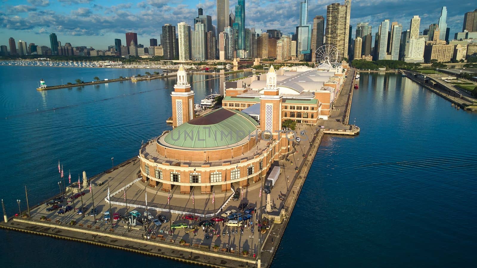 Image of Aerial over end of Navy Pier during vintage car show with view of Chicago downtown skyline