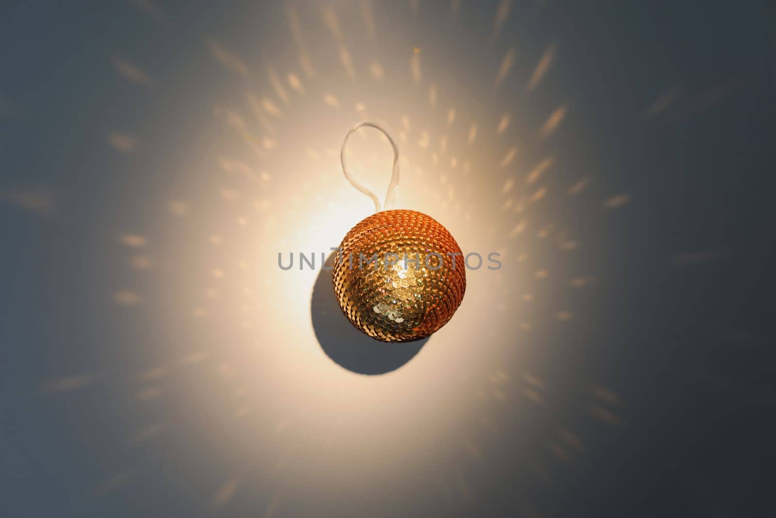 Colorful Christmas ball and sparkles on white background, top view. Space for text. Mirror ball lights background. Christmas decorations and New Year holiday background