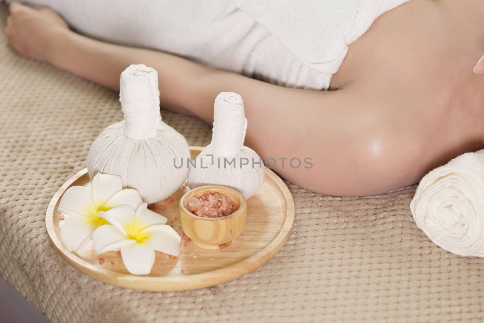 Young woman doing relaxing massage in spa salon. Female being massaged by a masseur. Spa and medicine concept.