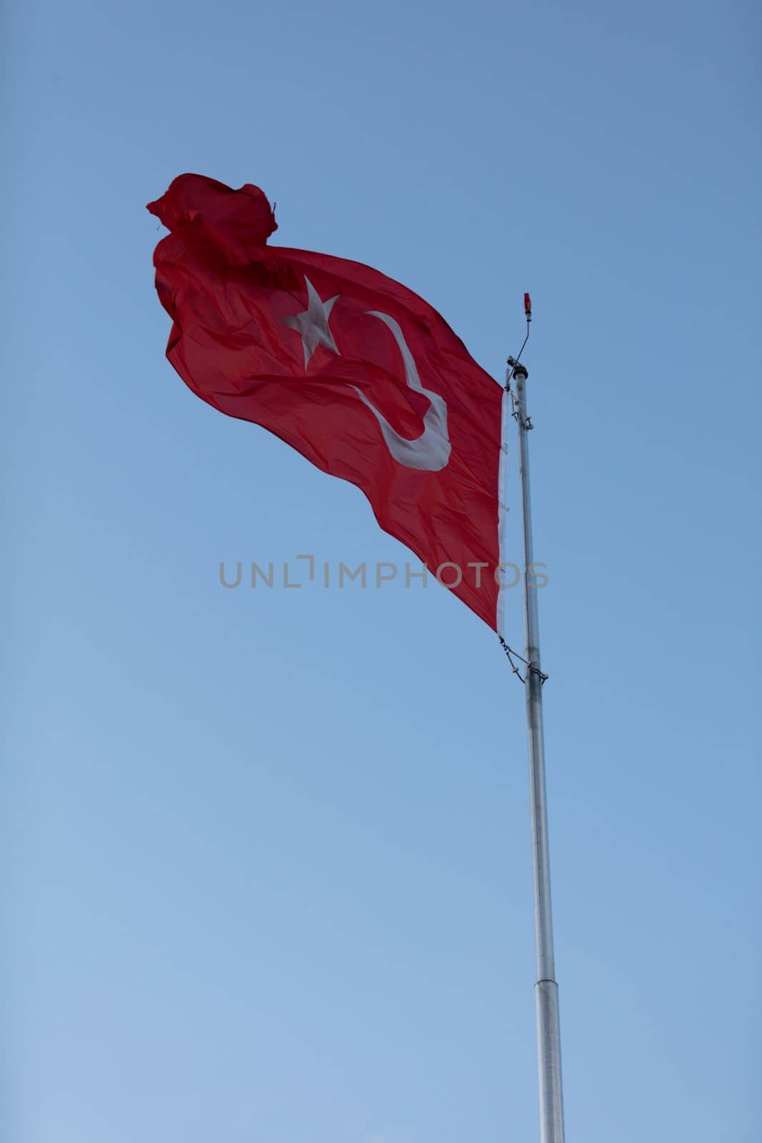 Turkish flag waving in blue sky by senkaya
