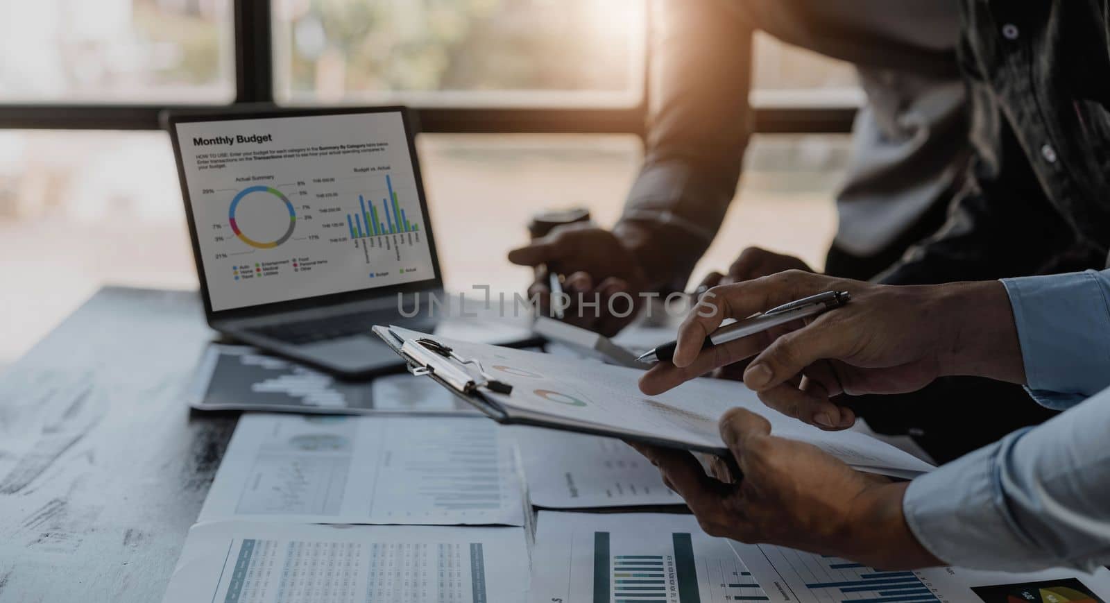 Business People Meeting using laptop computer,calculator,notebook,stock market chart paper for analysis Plans to improve quality next month. Conference Discussion Corporate Concept...
