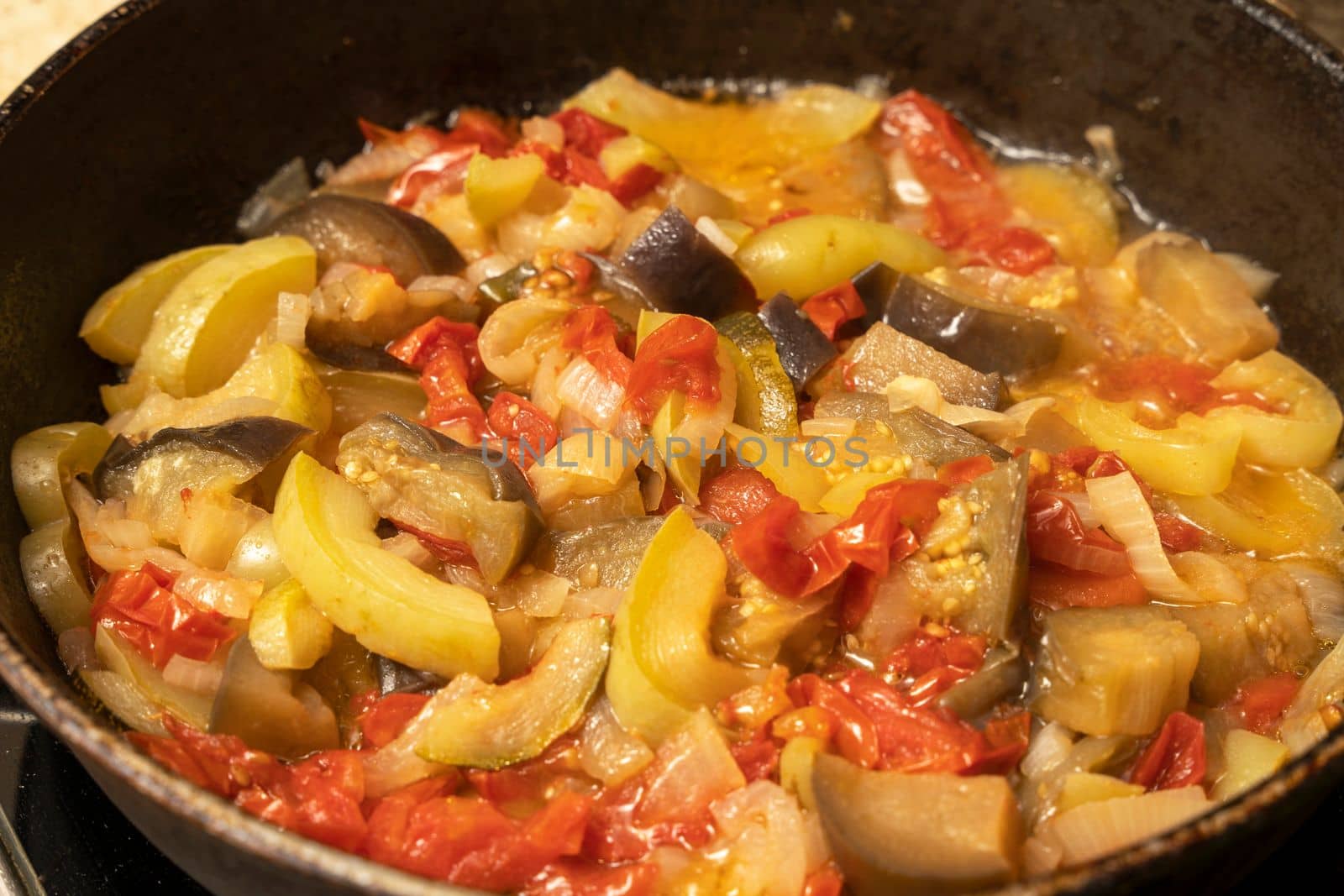 delicious juicy hot vegetable stew. ratatouille is cooked in a frying pan. High quality photo