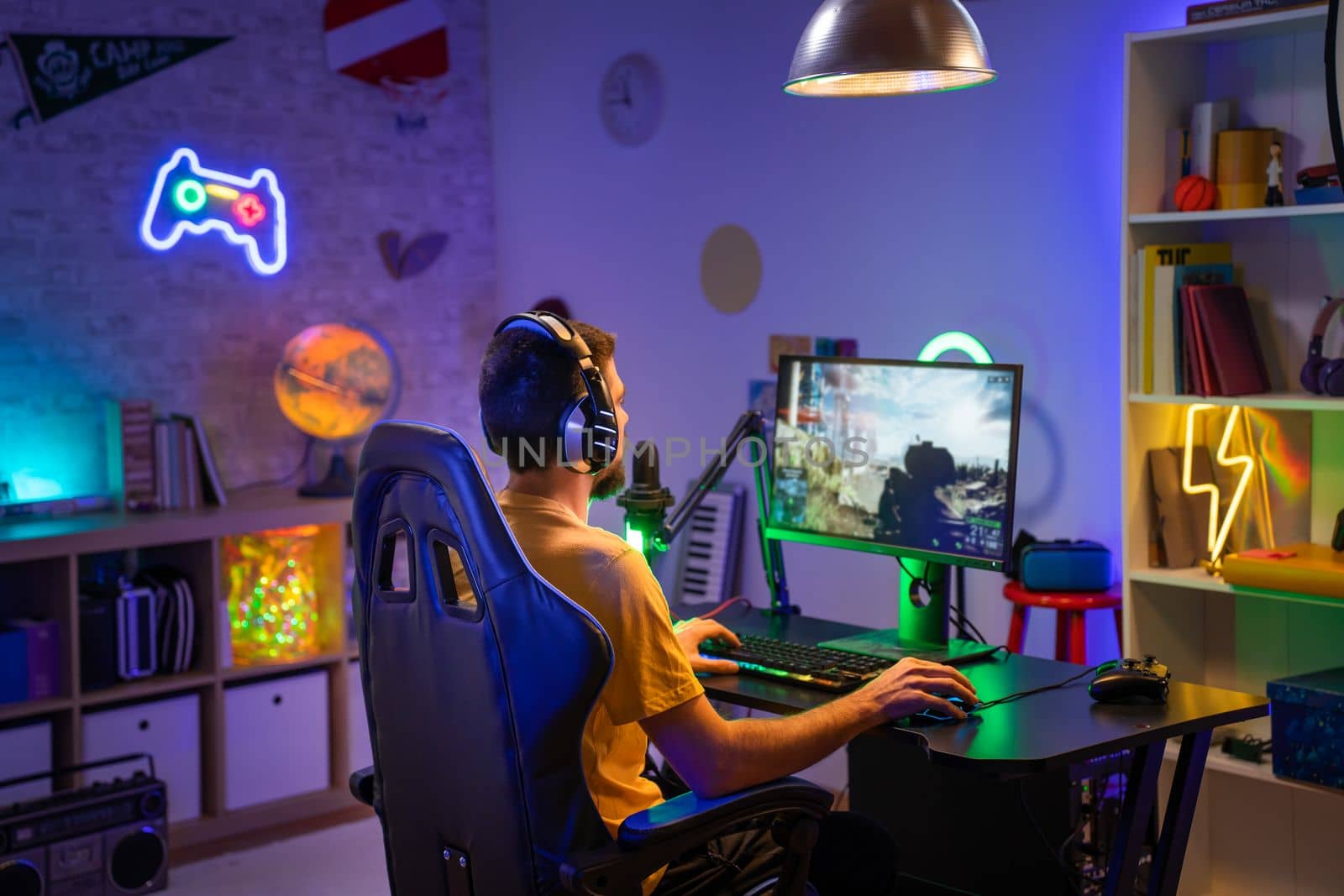 Gamer Playing Online Video Game on Computer with Colorful Neon Led Lights. High quality photo