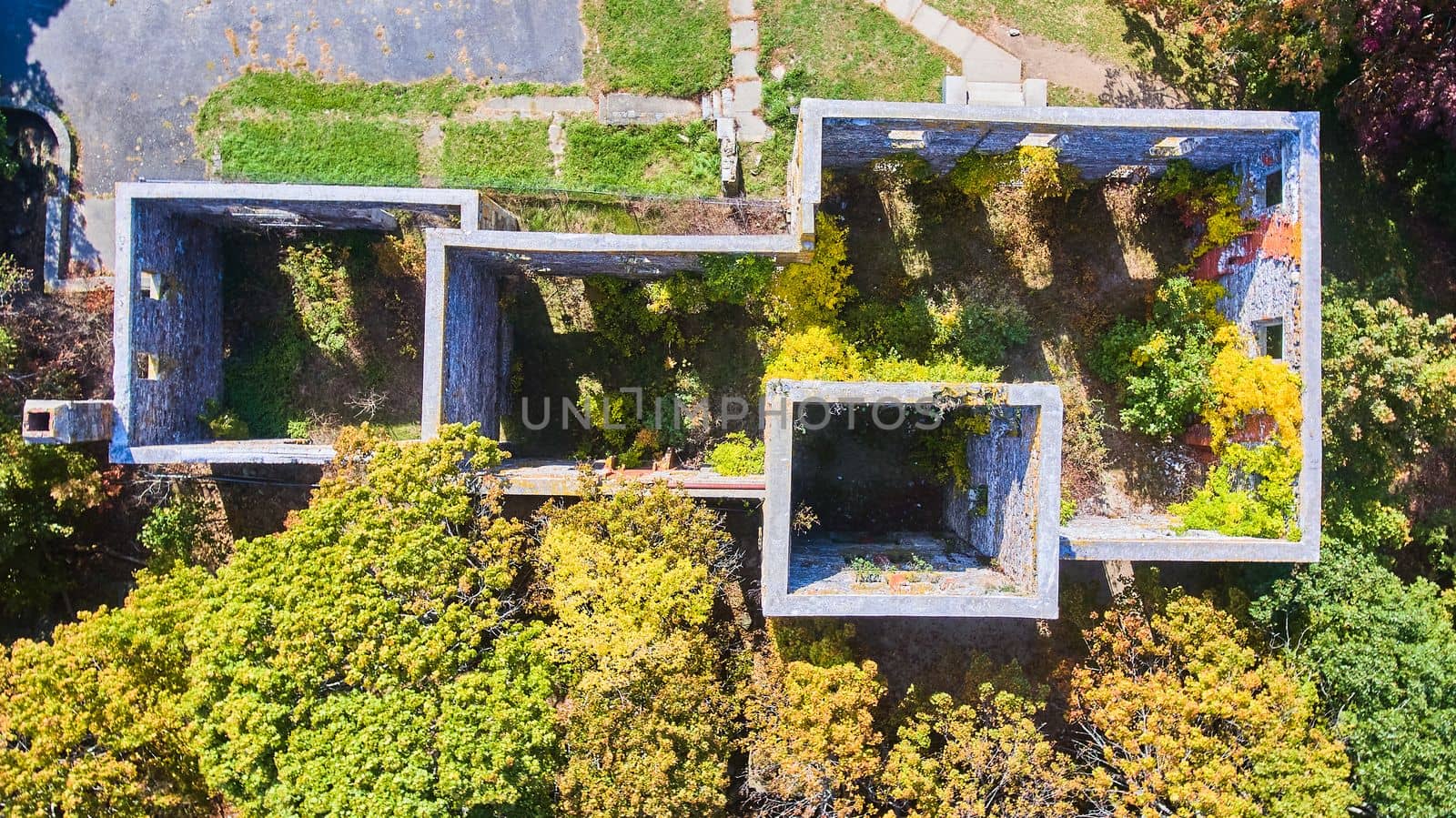 Image of Aerial looking straight down on old abandoned stone building with empty interior and no roof