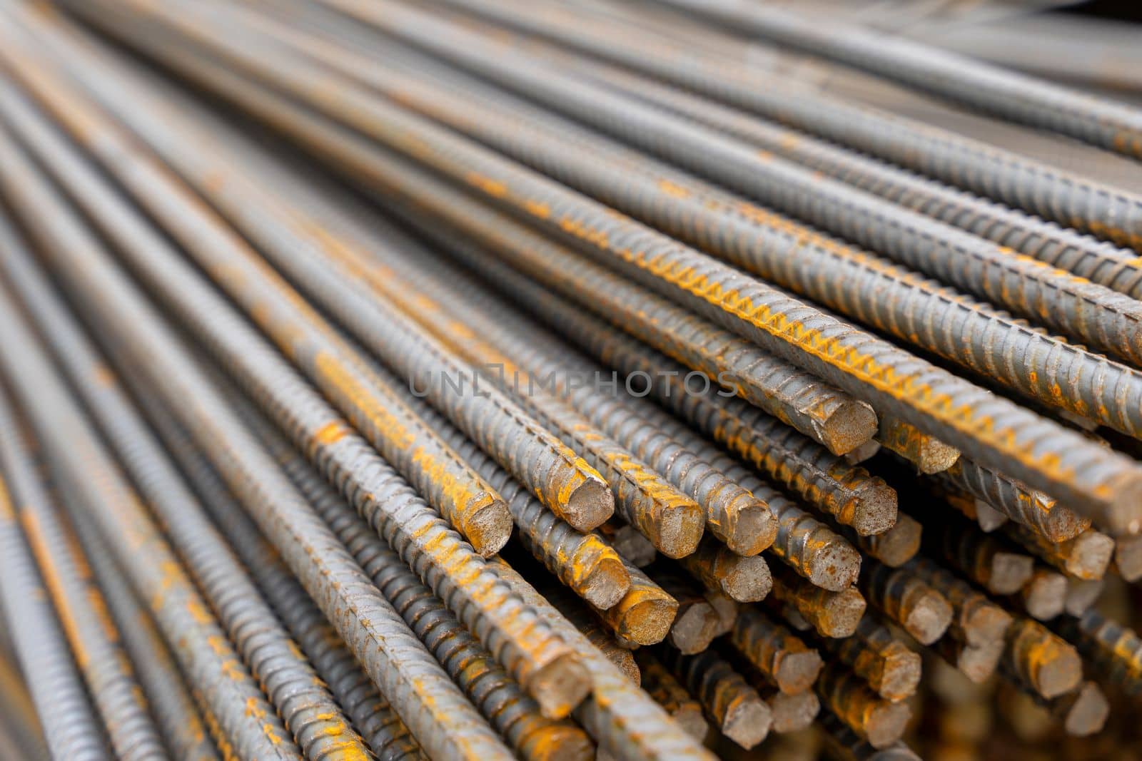 A large bundle of iron construction fittings in close-up. A bunch of new construction iron fittings on the construction site. High quality photo