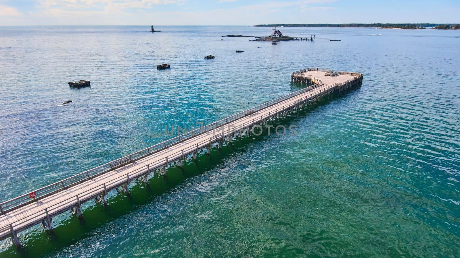Image of Long walking pier with view of island for lighthouse