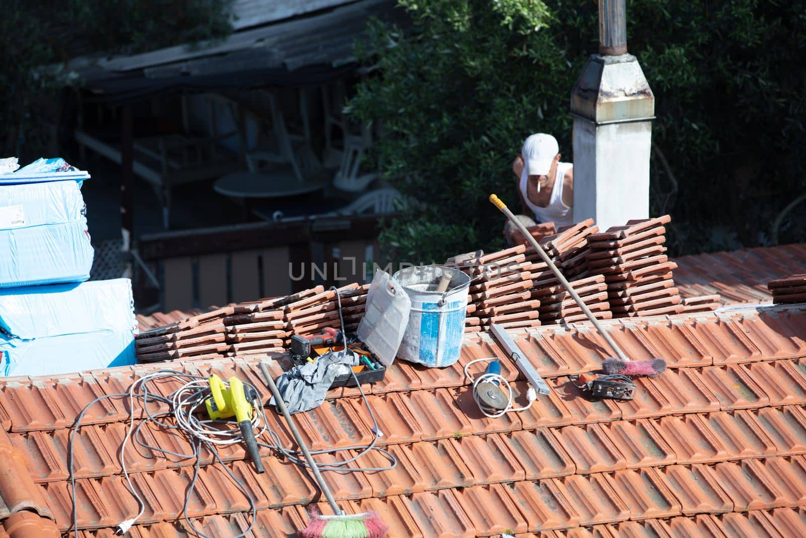 Construction Worker Tile Roofing Repair sunny day by senkaya