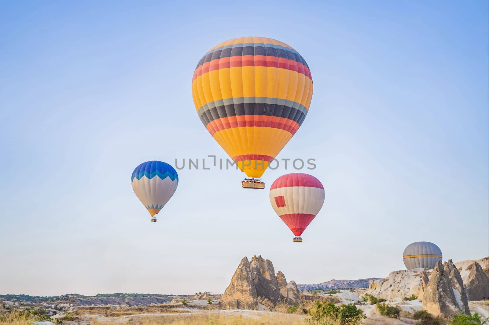 Colorful hot air balloon flying over Cappadocia, Turkey by galitskaya