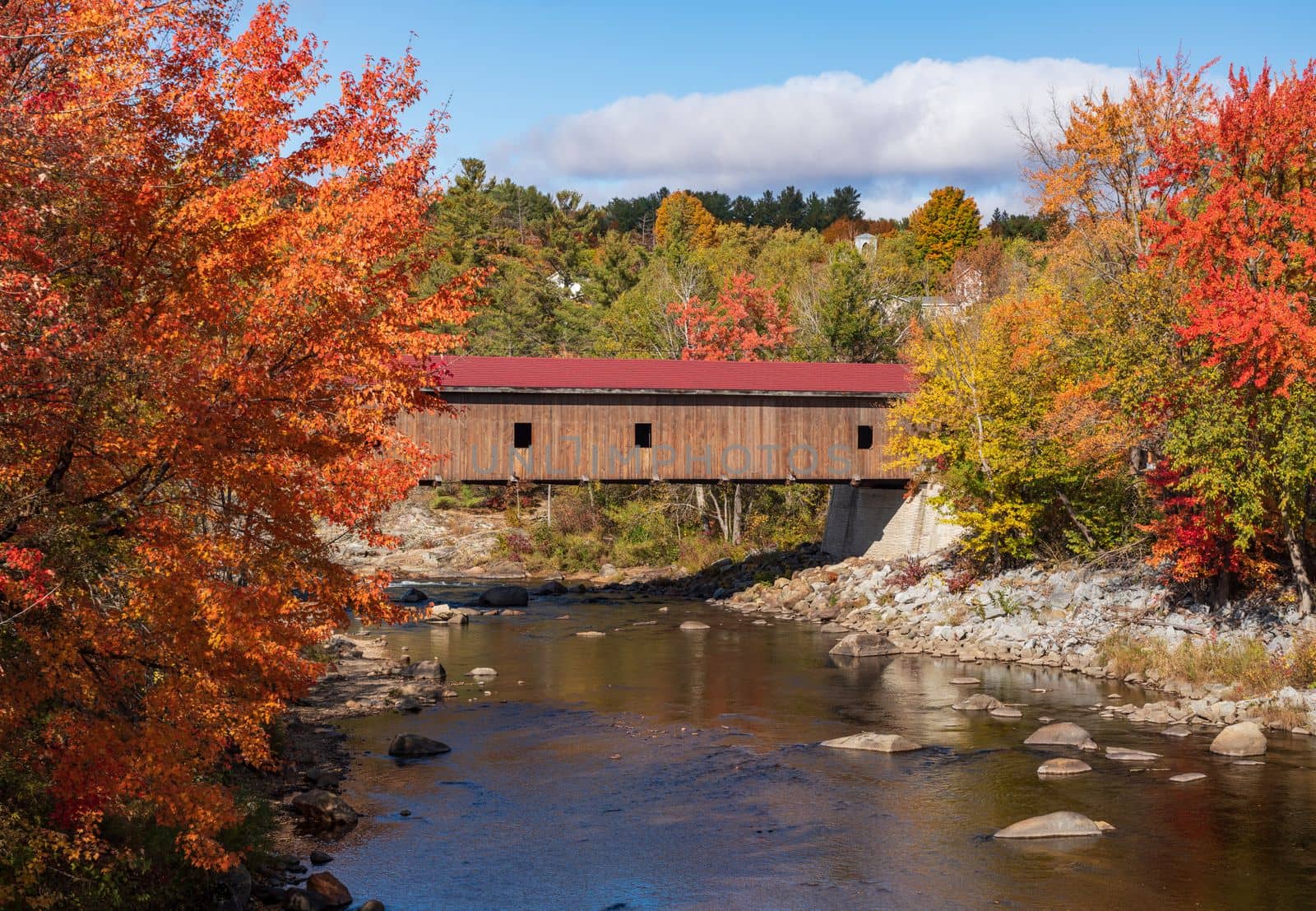 Colorful fall trees in the Adirondacks around Jay covered bridge in New York State in the autumn