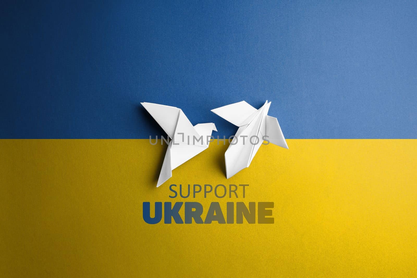 two white paper dove in the center on background with words support Ukraine, with blue yellow color. symbol of freedom