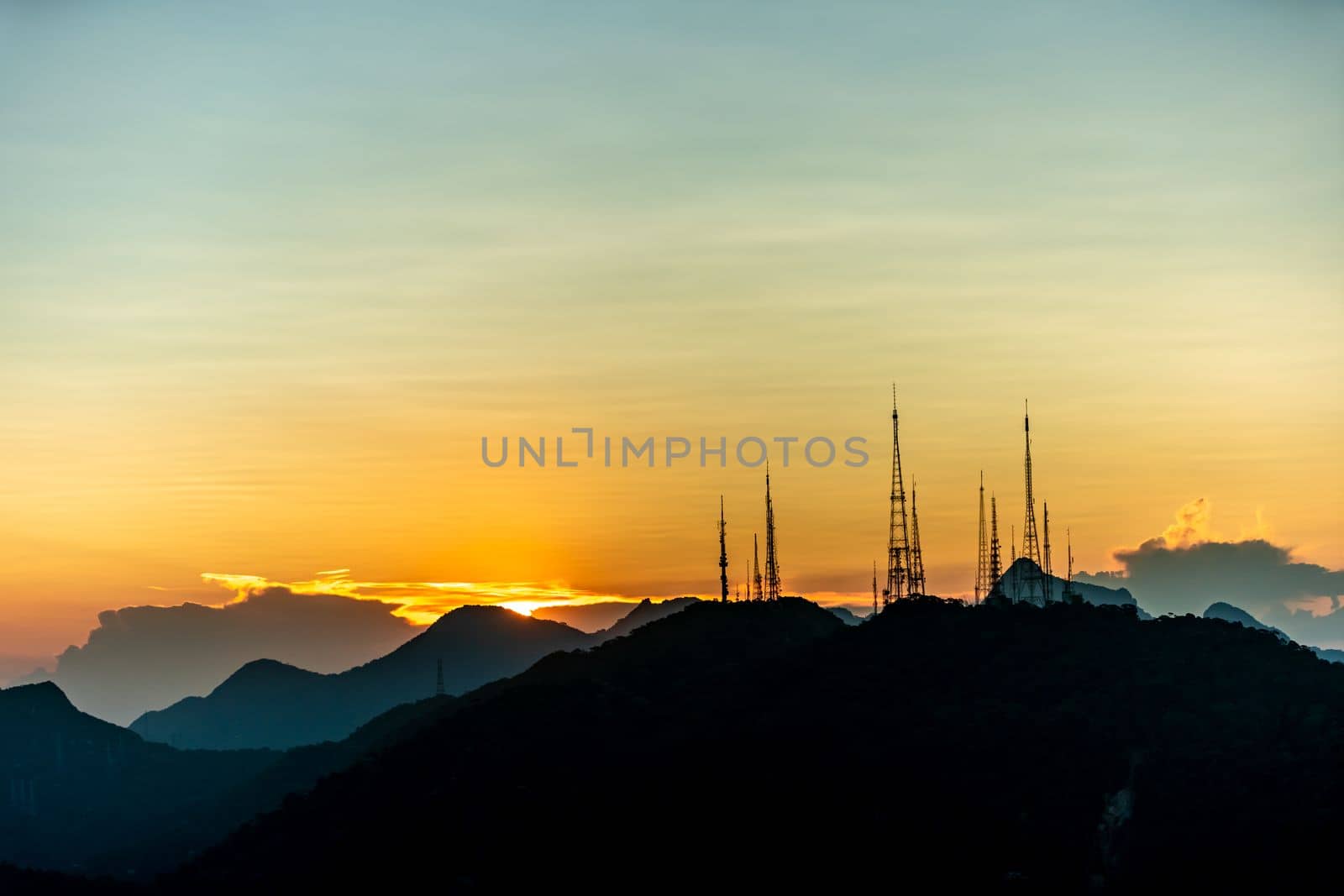 sunset over the transmission towers in rio de janeiro, view from the statue of christ. 