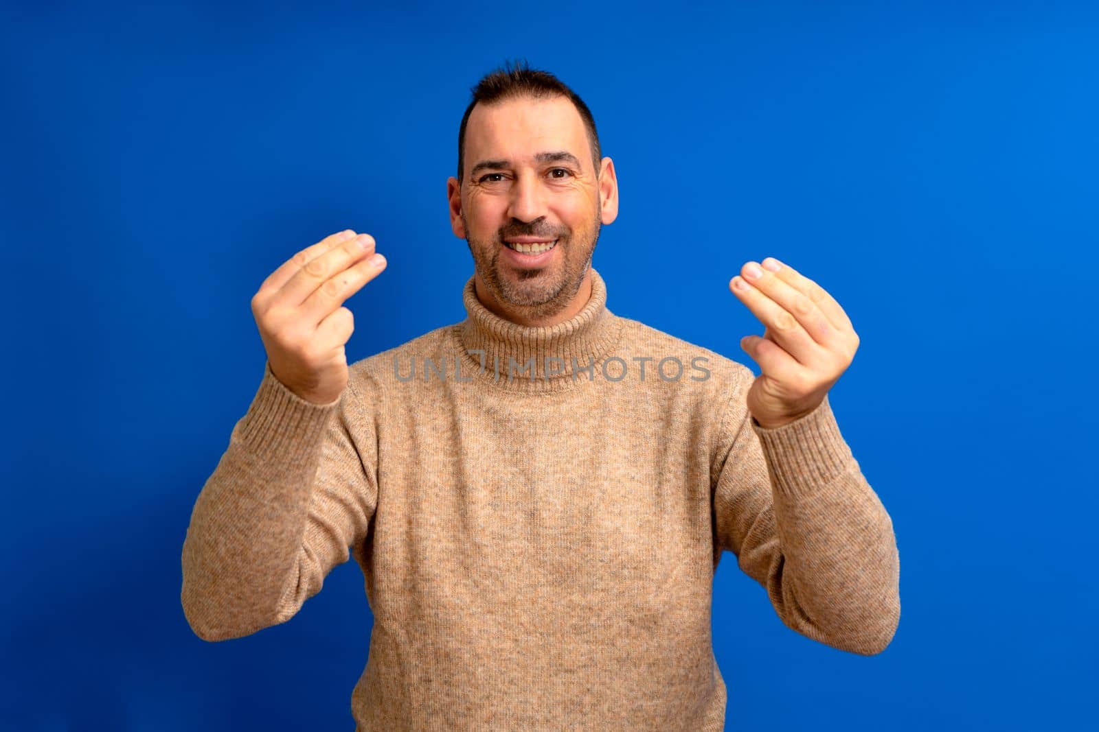 Hispanic man about 40s with beard standing over blue isolated background doing italian gesture with hands and fingers confident expression