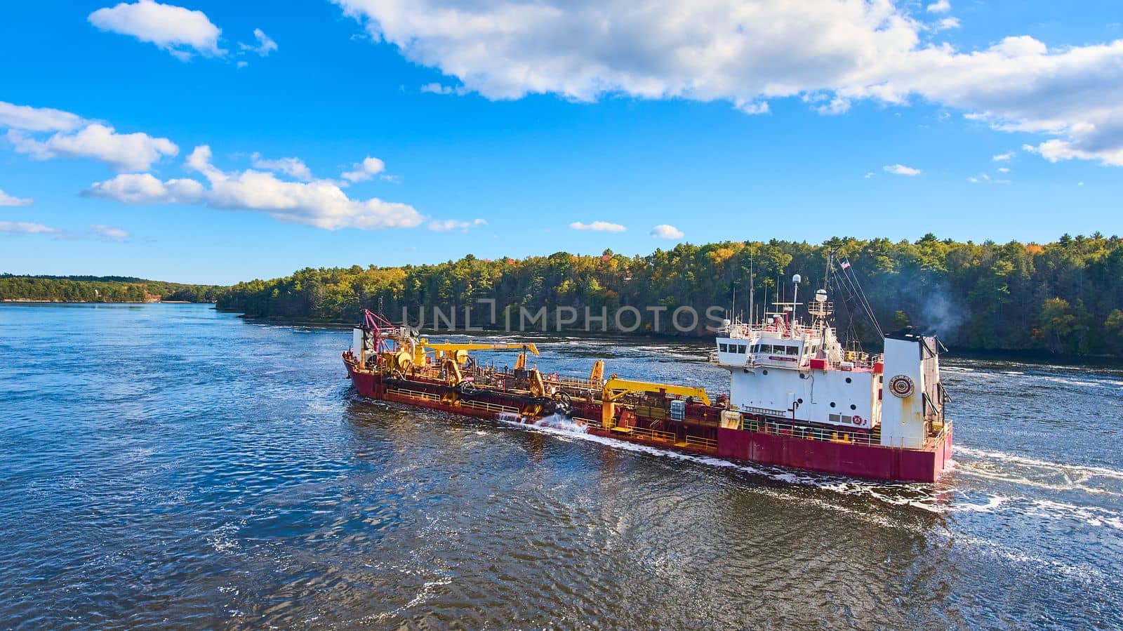 Commercial ship from above sailing through river in Maine by njproductions