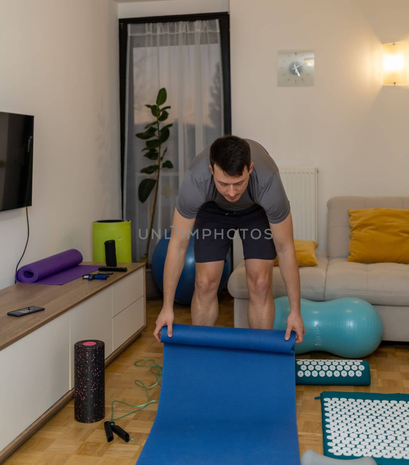 young man in headphones meditating on couch. High quality photo