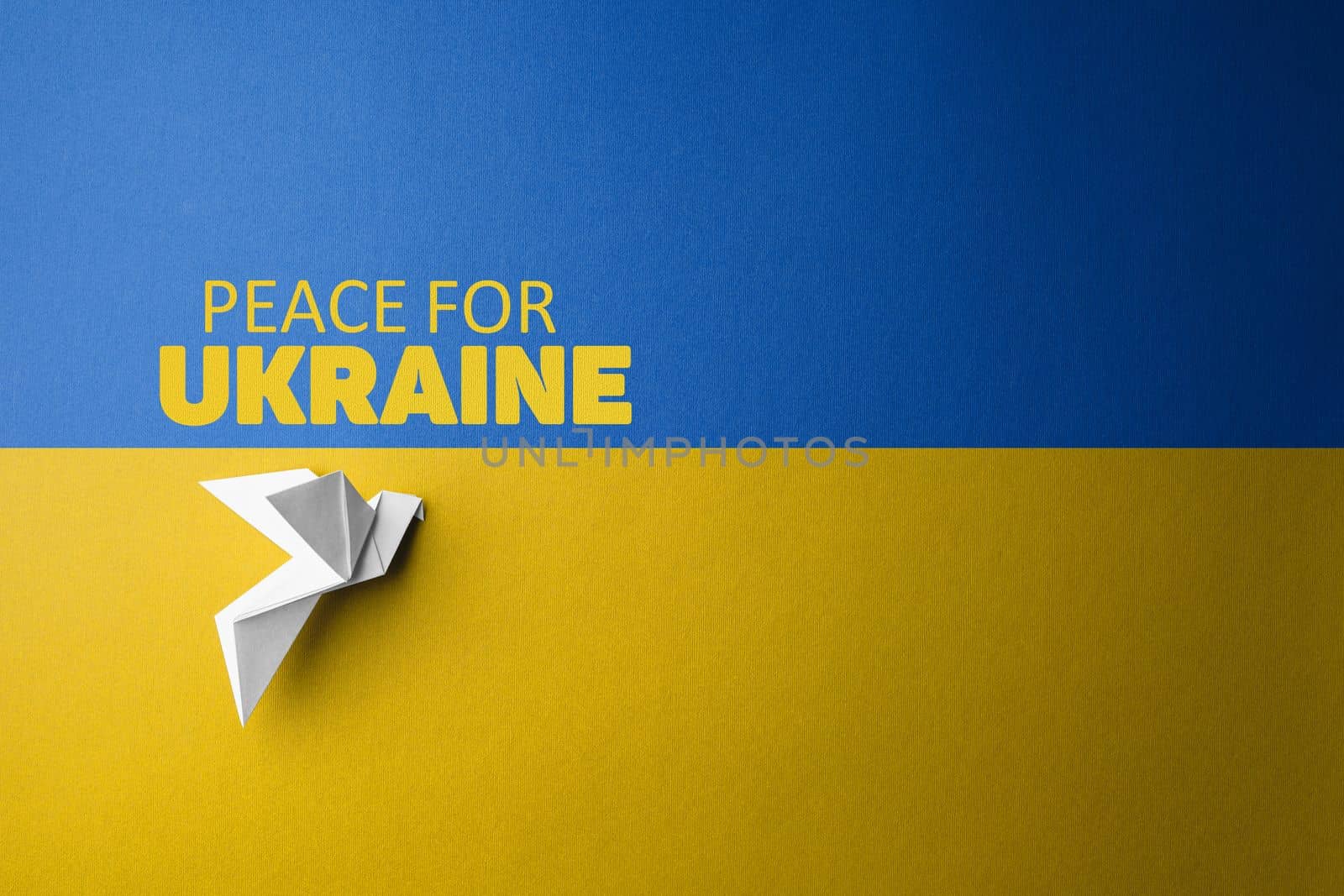 symbol of freedom white paper dove on the background of flag of ukraine with blue yellow color with words peace for Ukraine