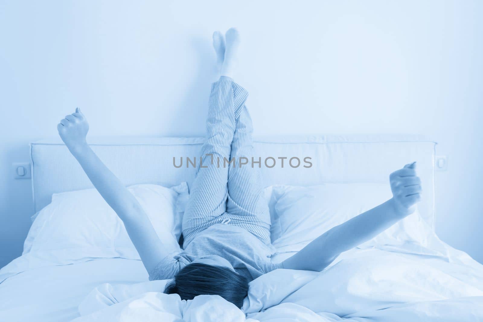Woman with legs and arms raised up high