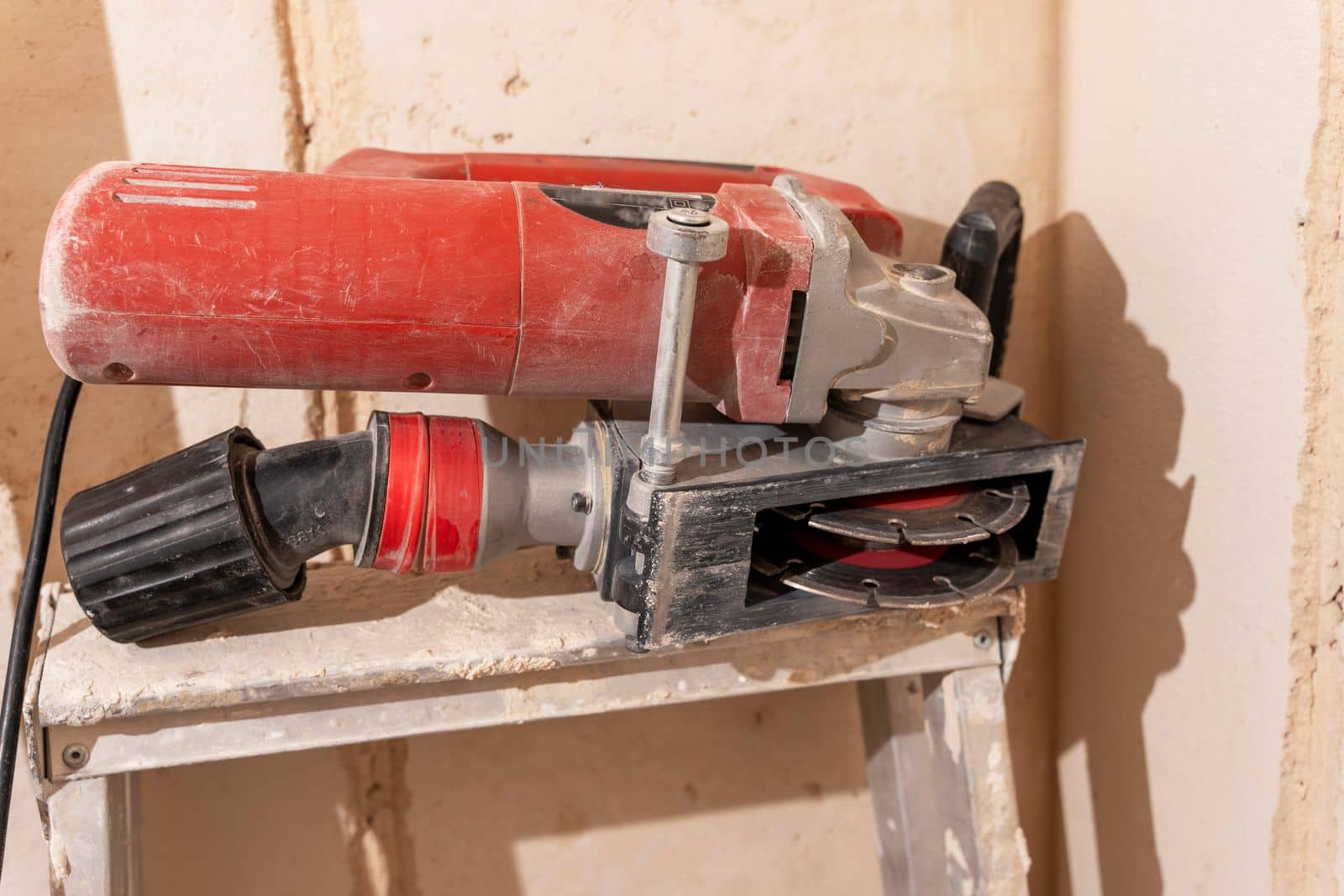 professional construction power tool for cutting grooves in concrete during the renovation of the apartment. A hand-held power tool with two diamond discs for cutting grooves in the wall for laying electrics. Professional tool. Close-up