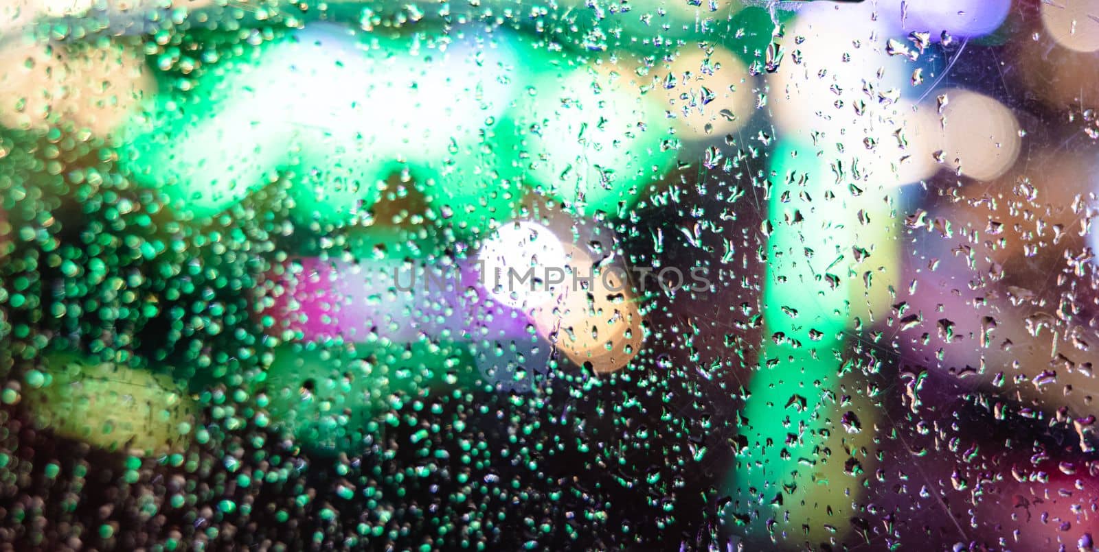 Rainy Night Bokeh Window. Water drop on glass