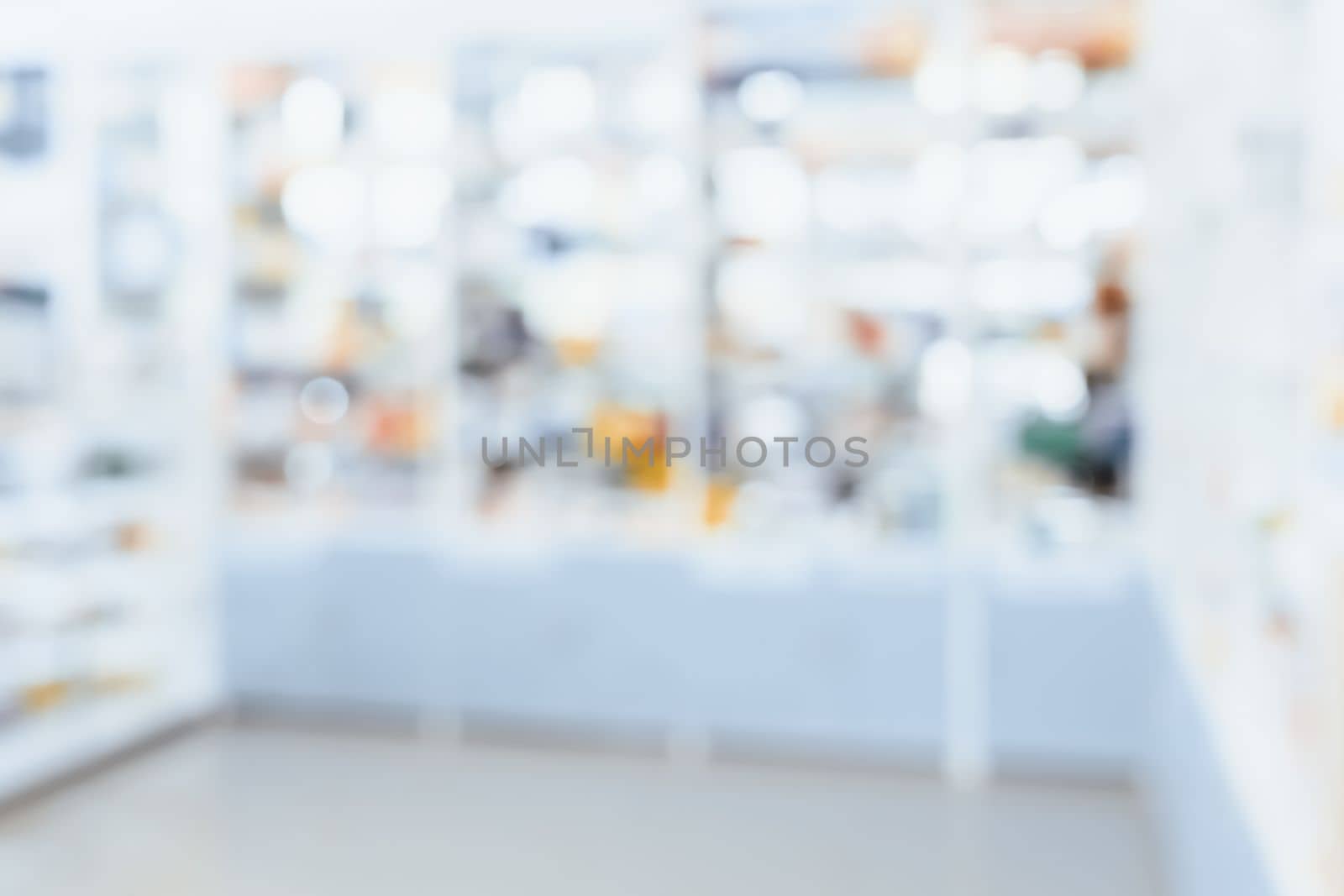 Pharmacy blurred abstract background qualified drug, medicinal product on shelf background. Blurry light tone wallpaper of drugstore's interior medications displayed on shelves for healthcare concept.