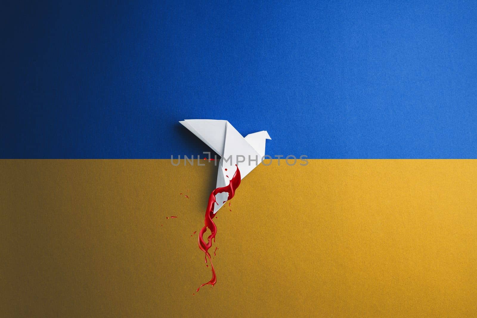 white paper origami dove bird in blood takes off and breaks free, on yellow blue background in color of ukraine flag. concept needs help and support, truth will win