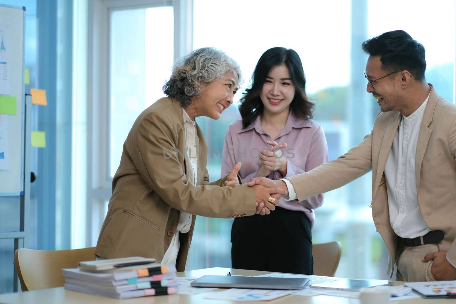 Business partnership handshake concept.Photo two coworkers handshaking process.Successful deal after great meeting by wichayada