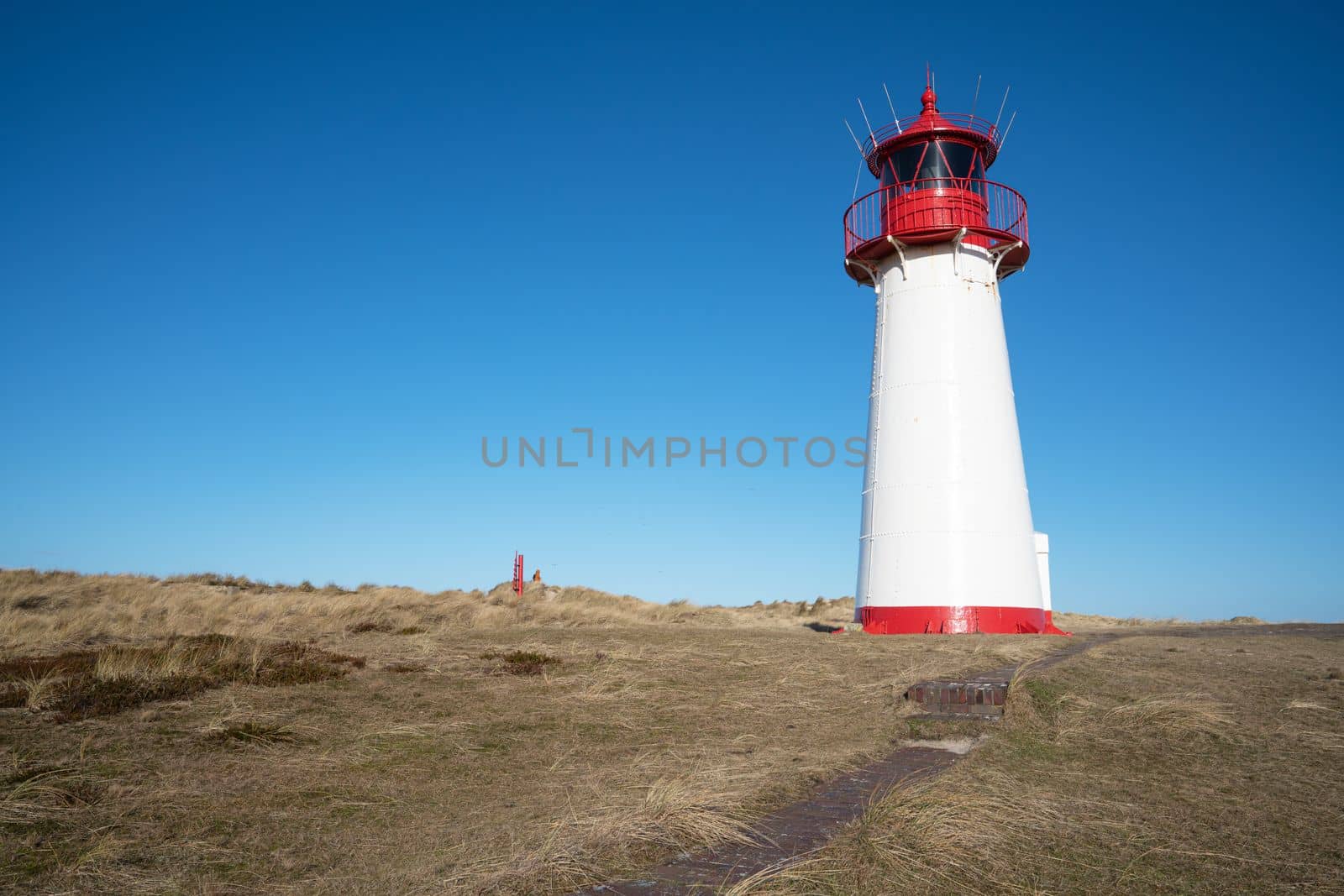 Panoramic image of List West lighthouse against blue sky, Sylt, North Frisia, Germany 