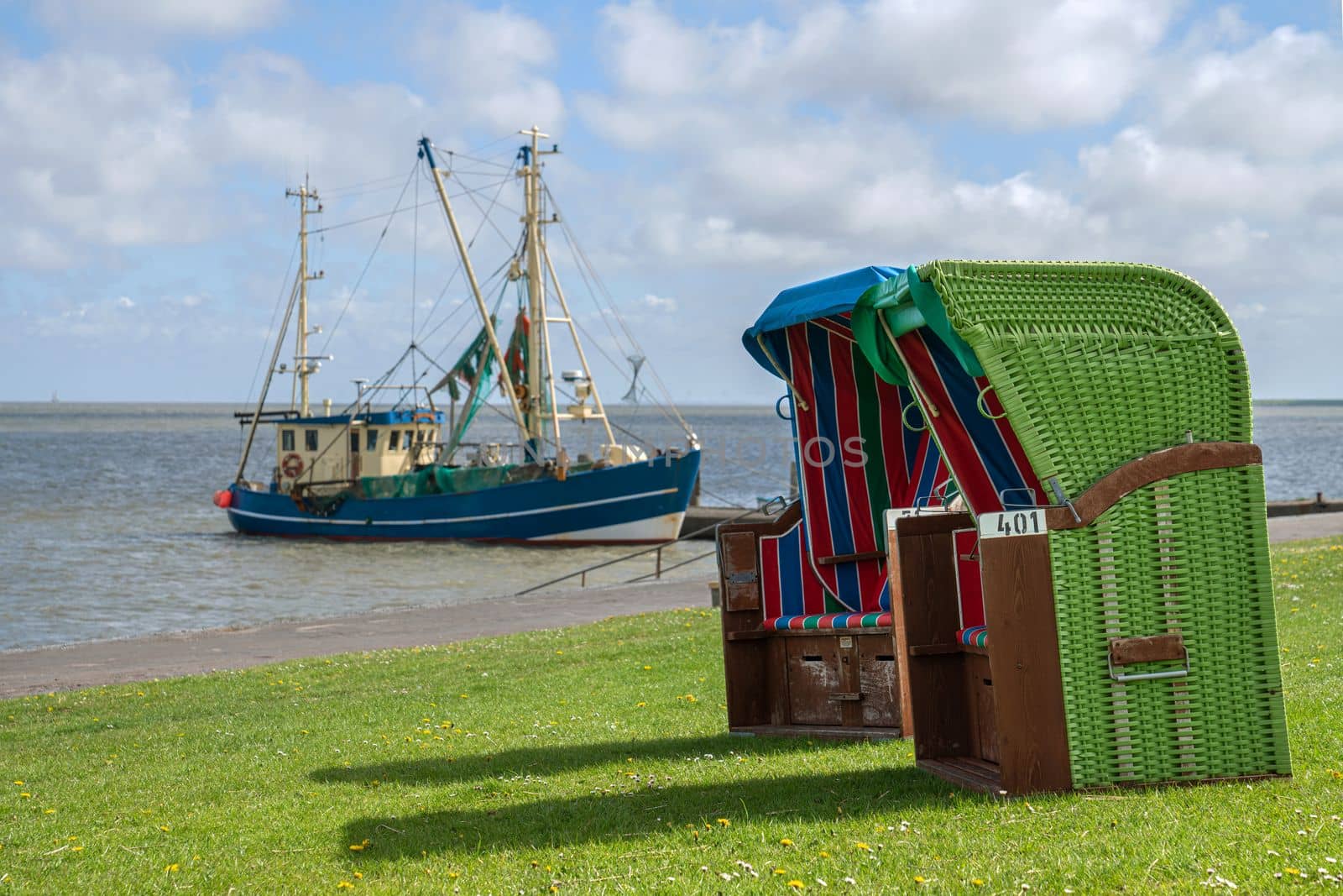 Panoramic image of the landscape along the dikes of Pellworm with beach chairs, North Frisia, Germany 